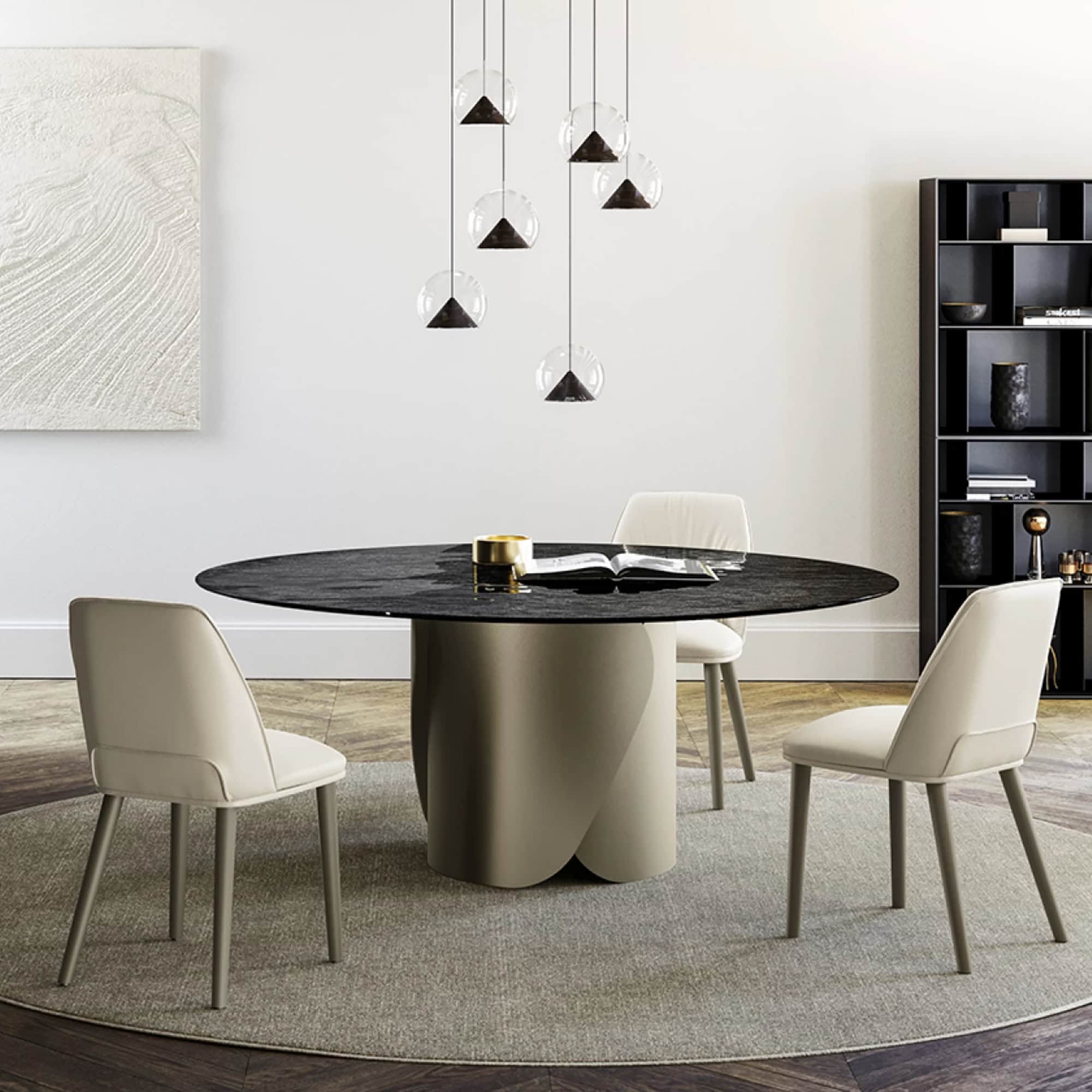 Contemporary dining room with round black marble table, chic white chairs, and modern pendant lighting.