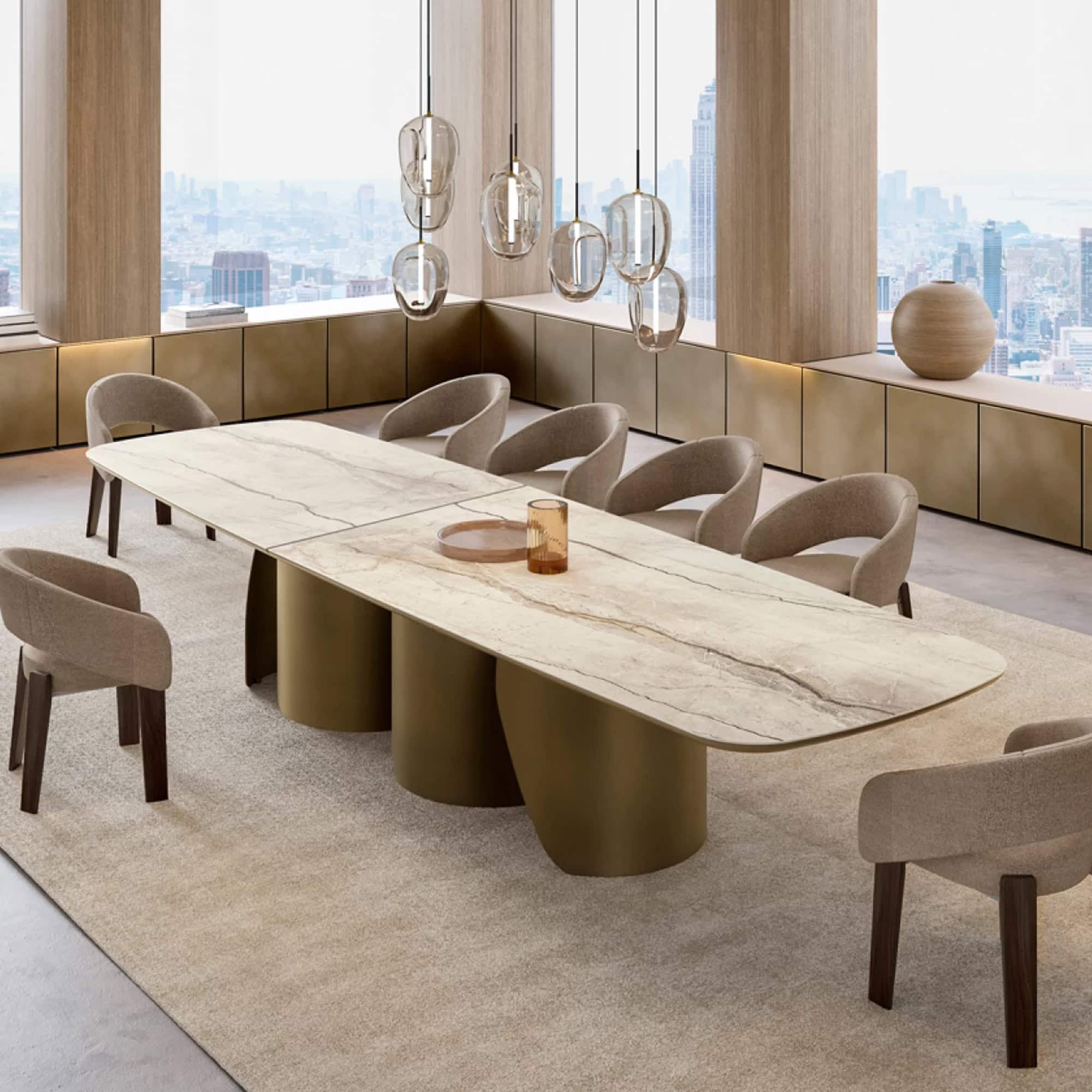Elegant marble conference table with gold base in a modern high-rise office.