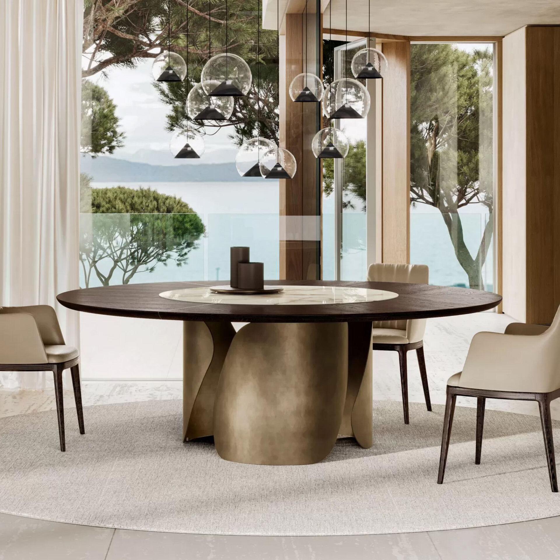 A luxurious dining room with a round dark wood table, beige chairs, and modern pendant lights, overlooking a serene sea and green trees through large windows.