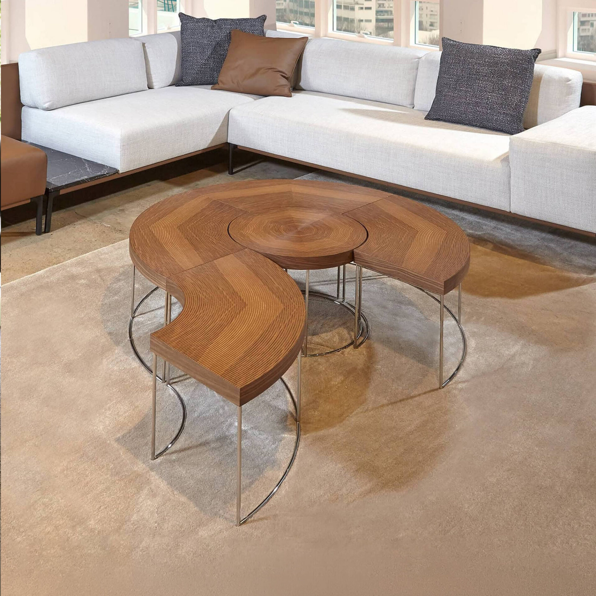 Sini Modular Coffee Table set in walnut with modular curved design and metal legs, styled in a contemporary living room.