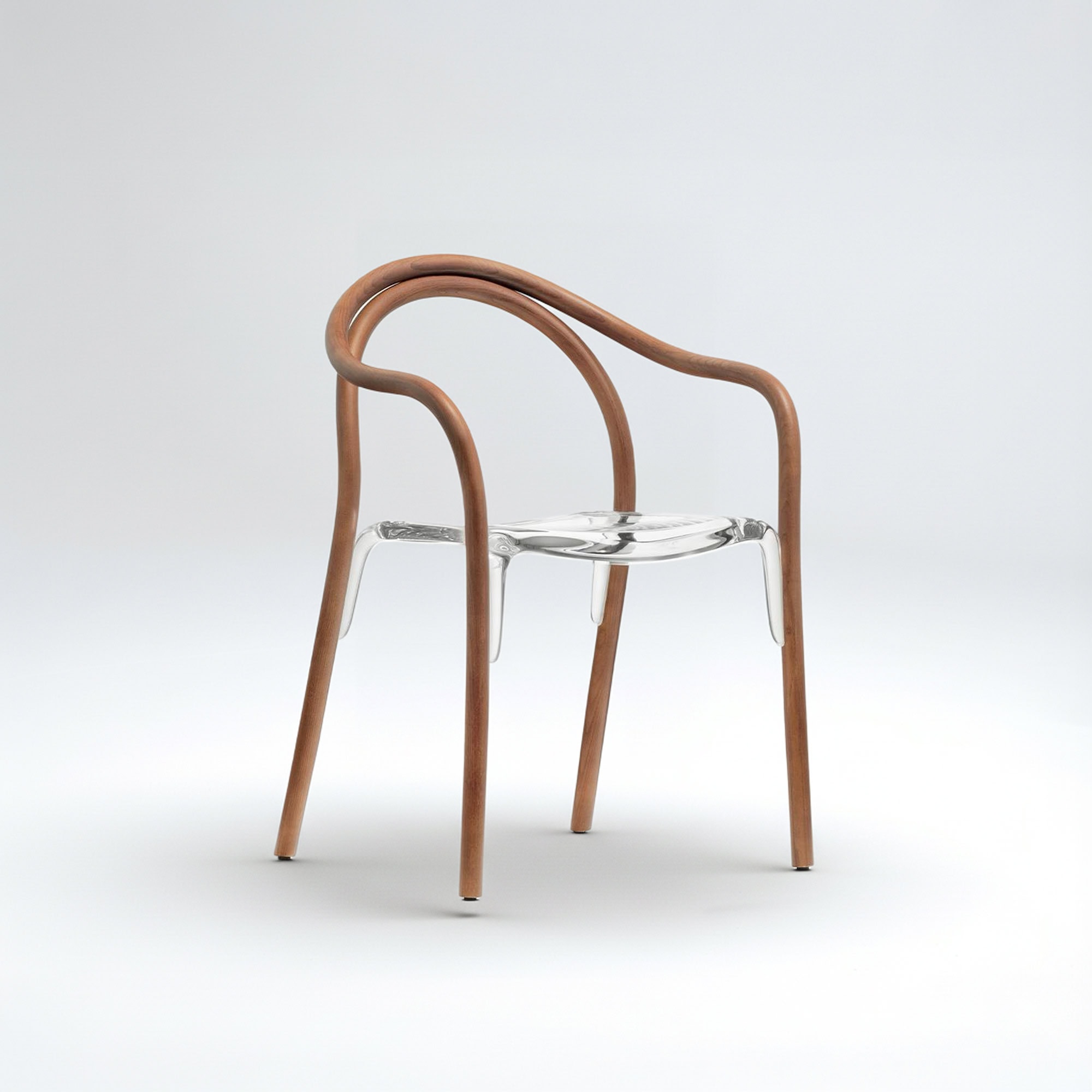 Contemporary acrylic and wood chair with curved armrests and minimalist design.