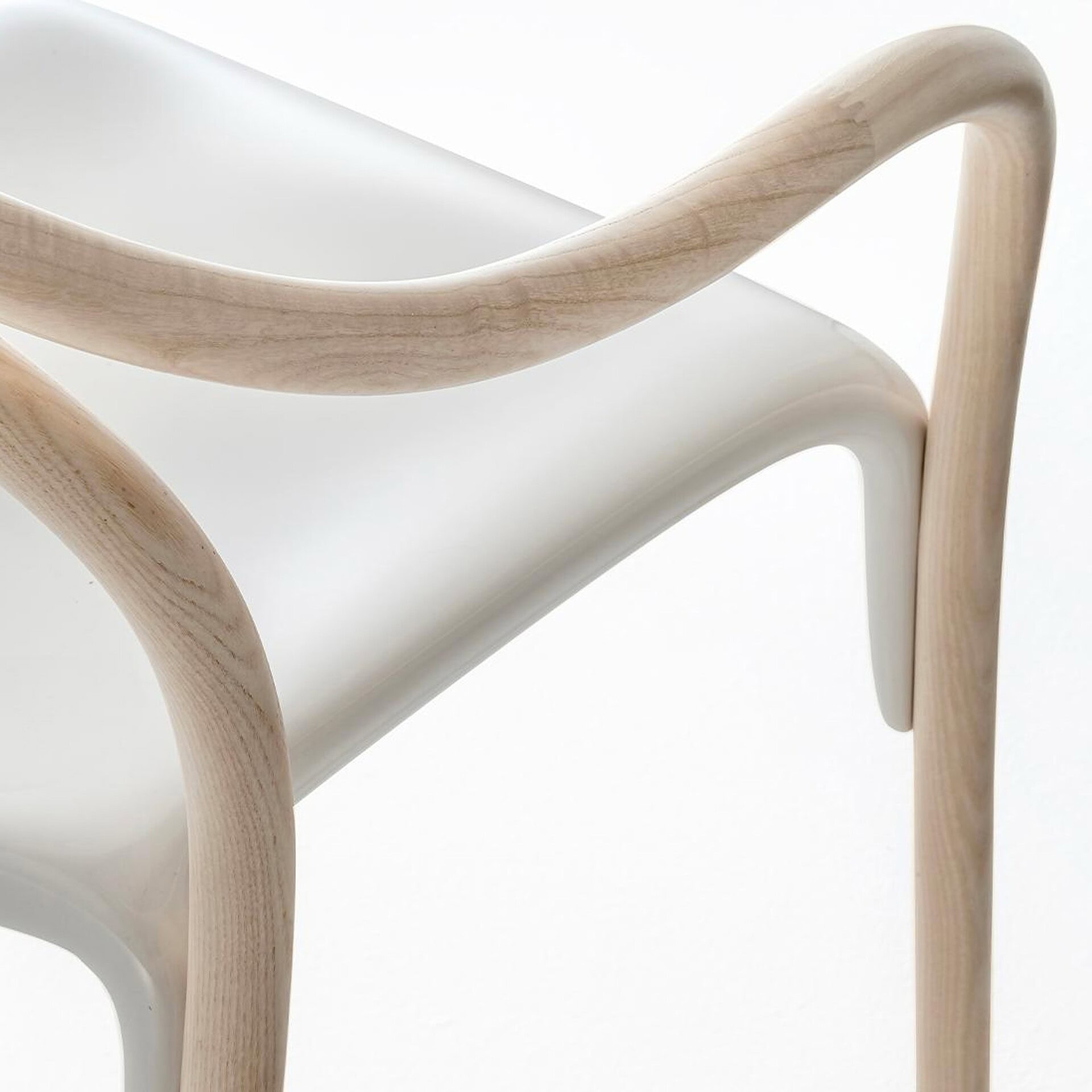 Detail view of Pedrali Soul 3745 Armchair showing natural ash frame and clear polycarbonate seat connection