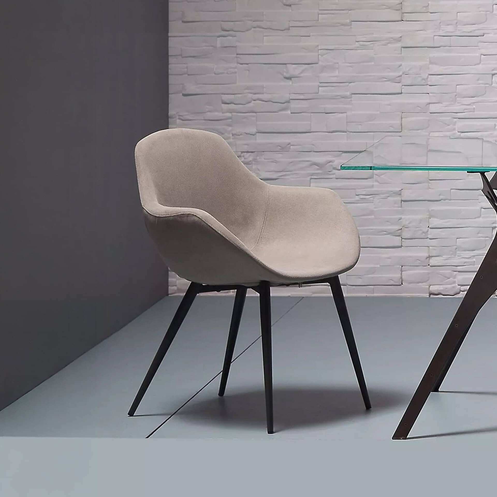 Upholstered Maya dining chair with modern design and black wooden legs. Perfect for contemporary din.