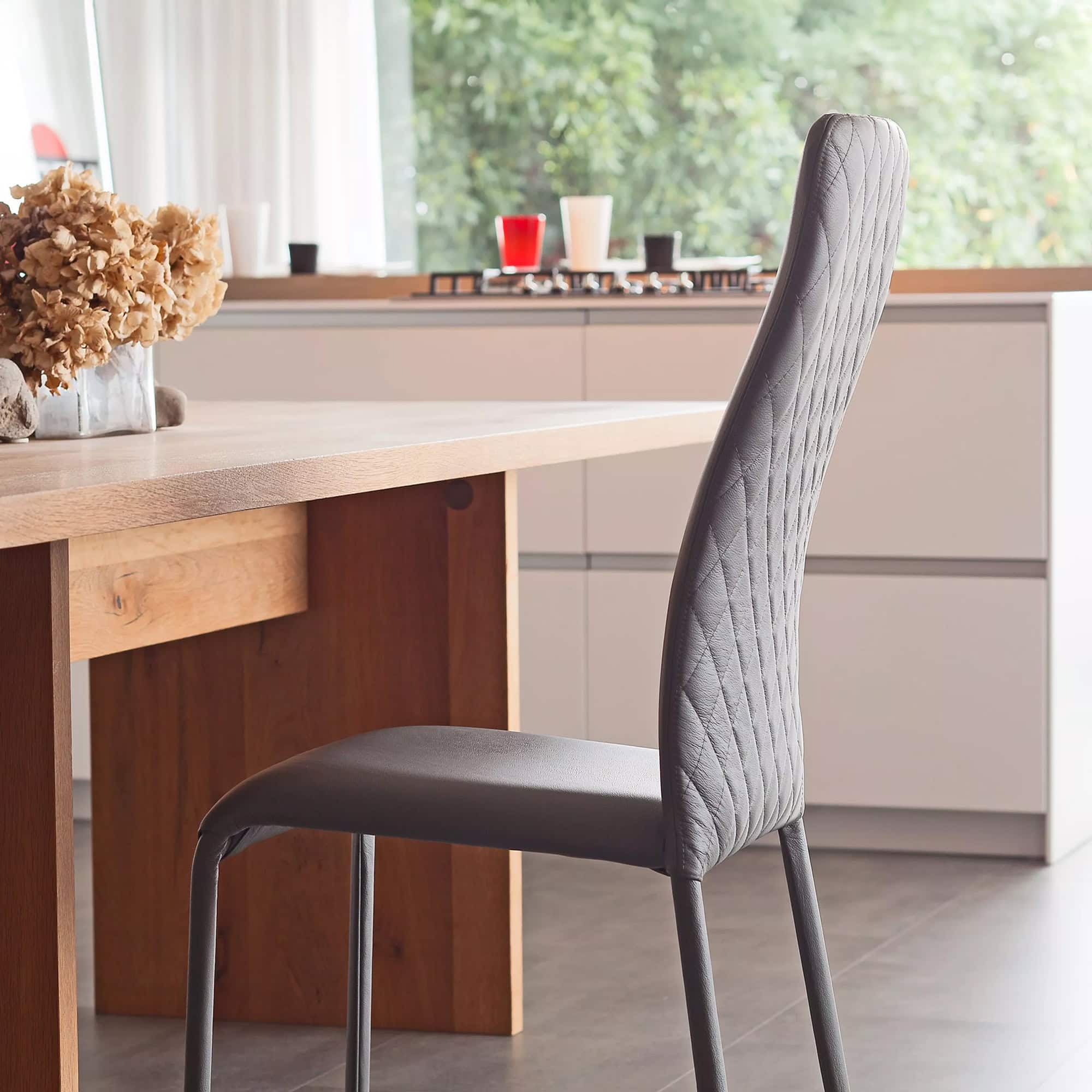 Swing High Back Dining Chair in a modern dining room setting with a black base finish.