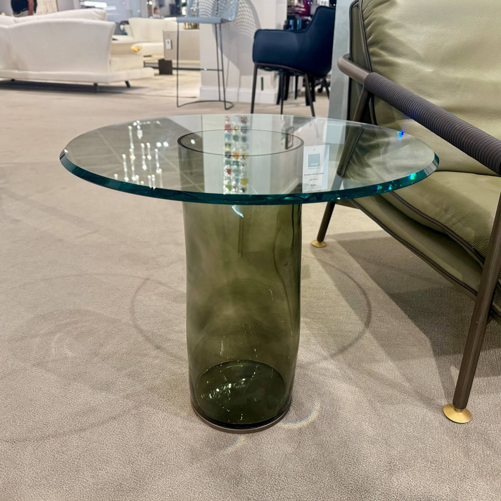 Side table with glass top and green base for modern interiors.