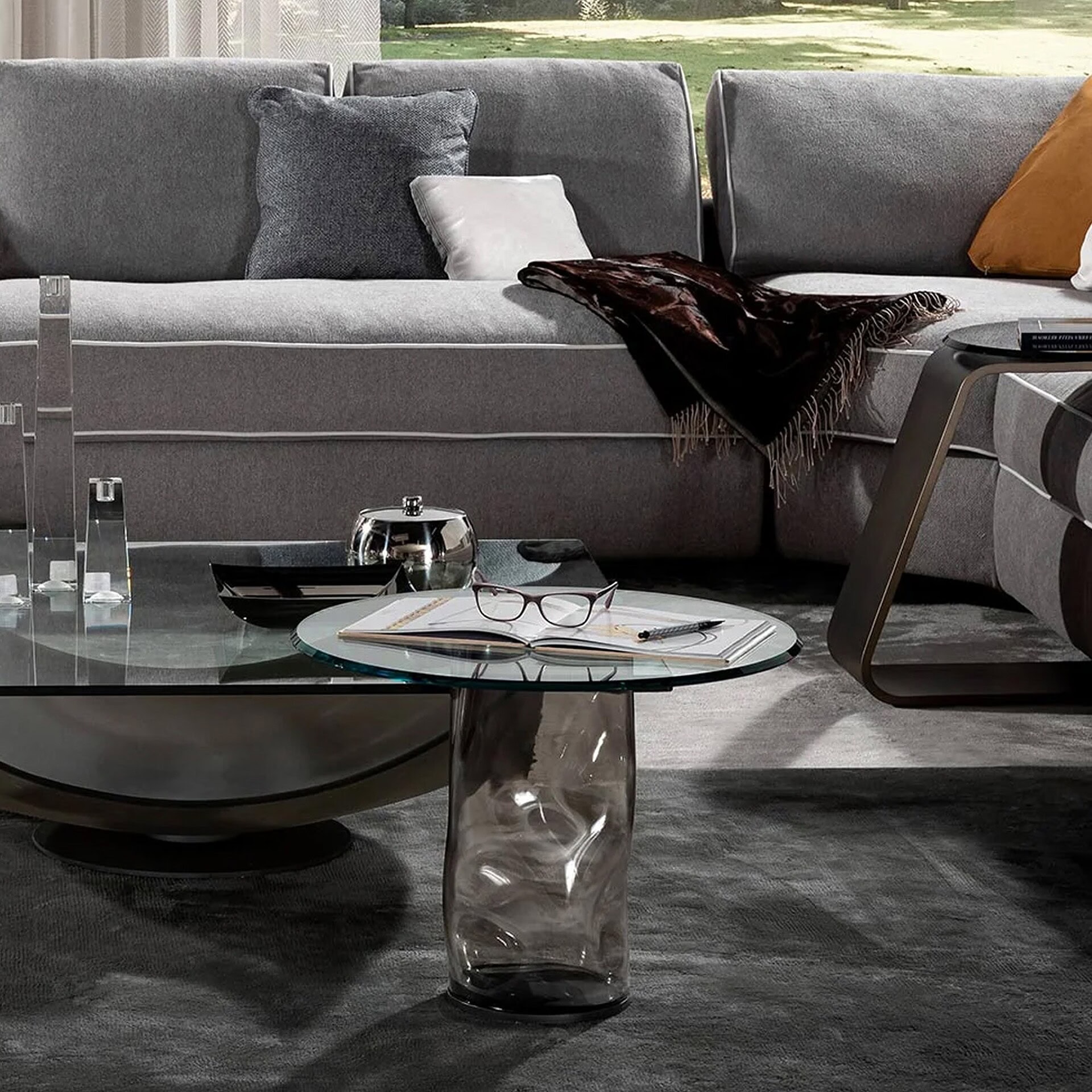 Dandolo 40 Side Tables in gray Murano glass displayed beside a contemporary sofa.