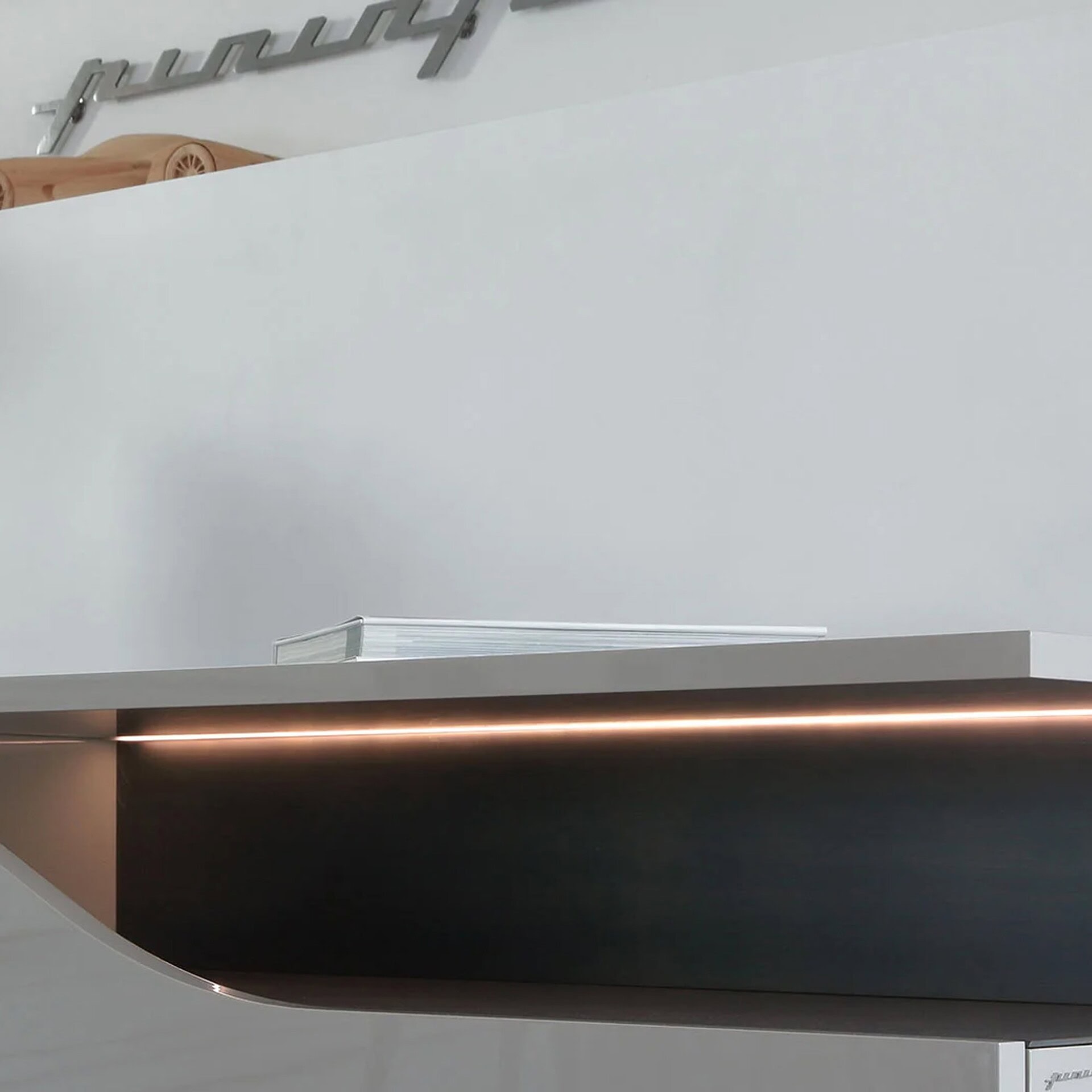 Close-up detail of the Segno Buffet shelf with metallic bronze finish.