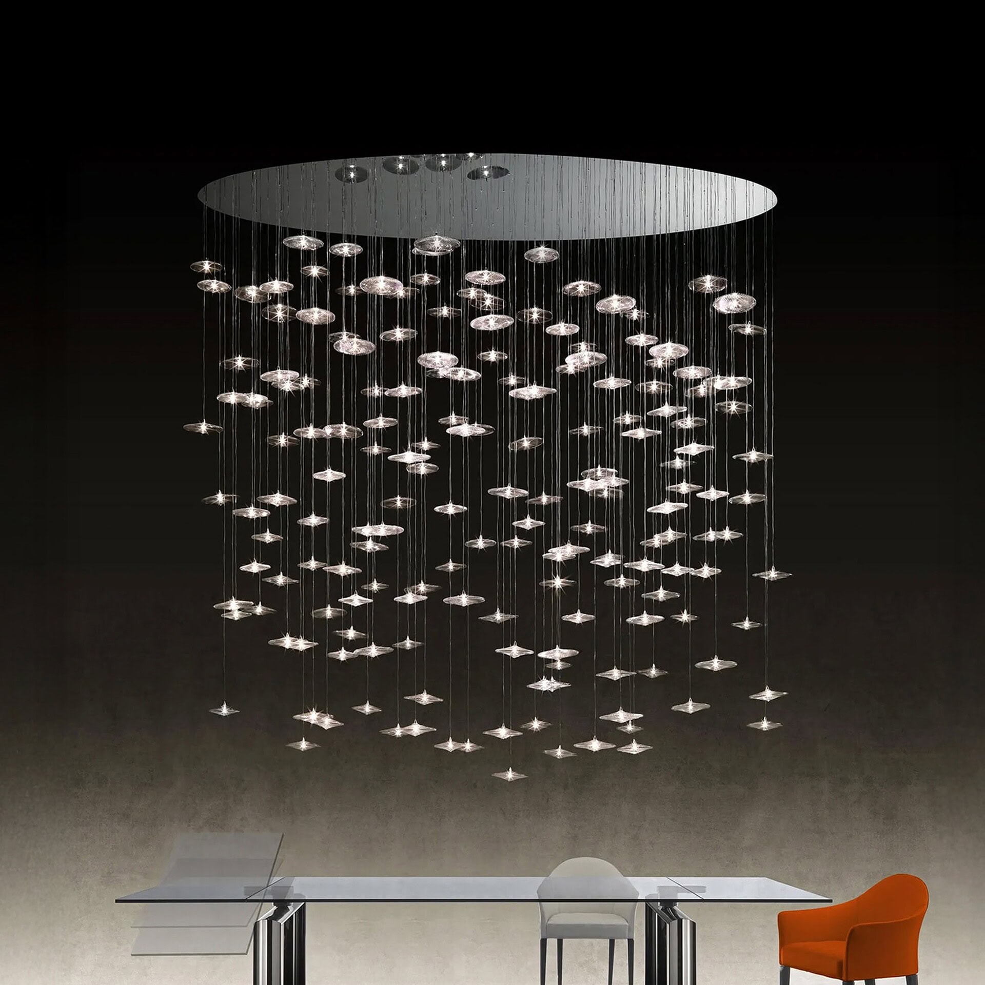 Sirius Modern Glass Chandelier in a circular arrangement suspended above a modern dining table.