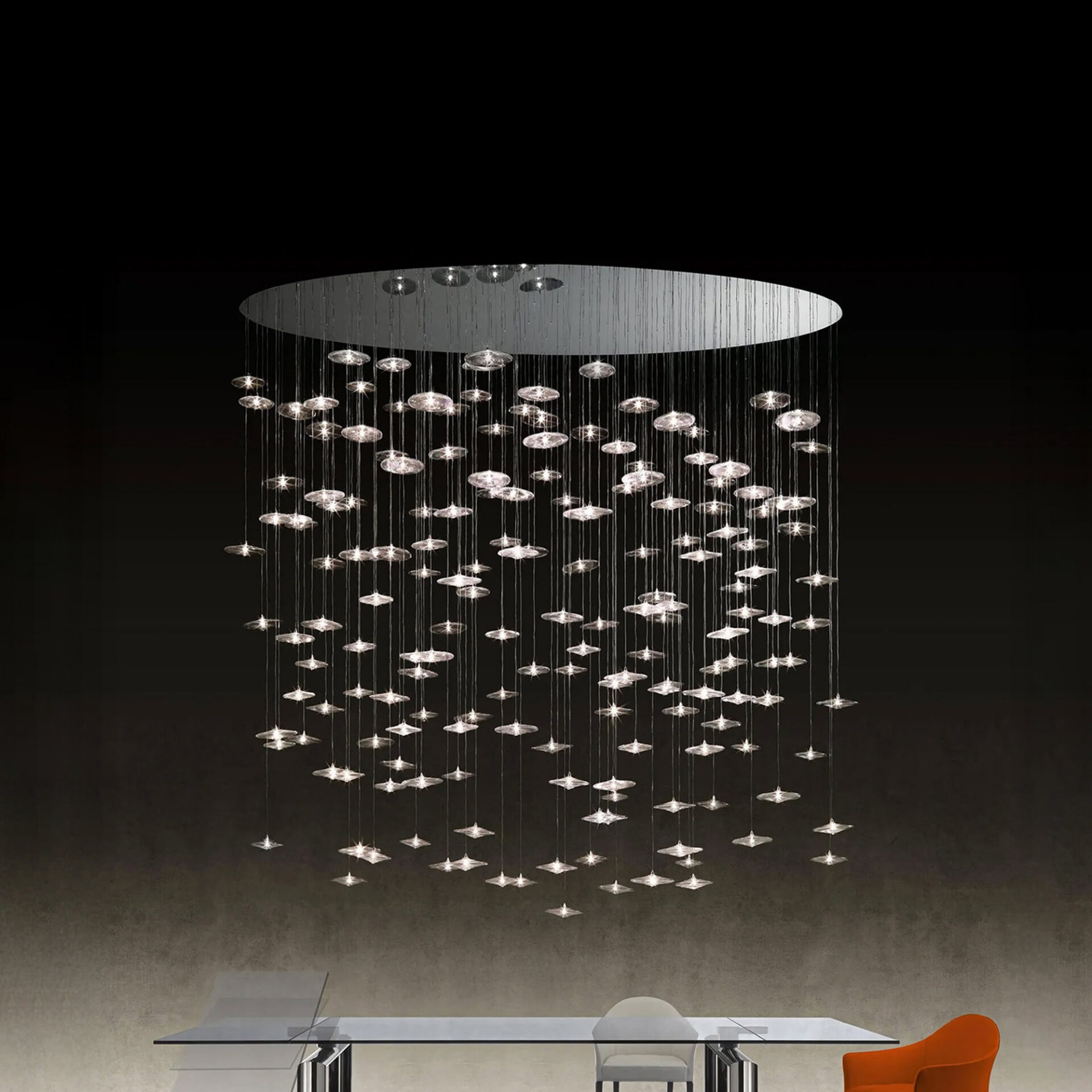 Sirius Modern Glass Chandelier in a circular arrangement suspended above a modern dining table.