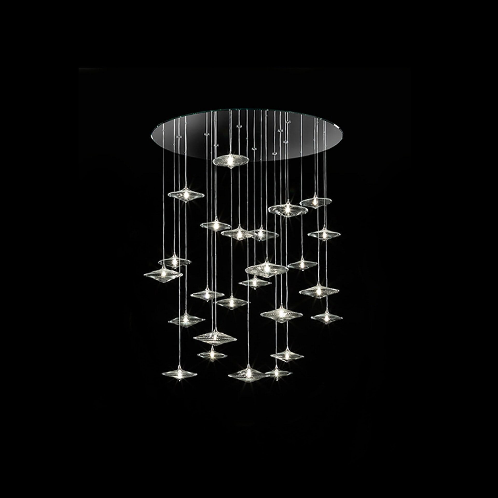 Close-up of Sirius Modern Glass Chandelier cluster glowing against a dark backdrop.