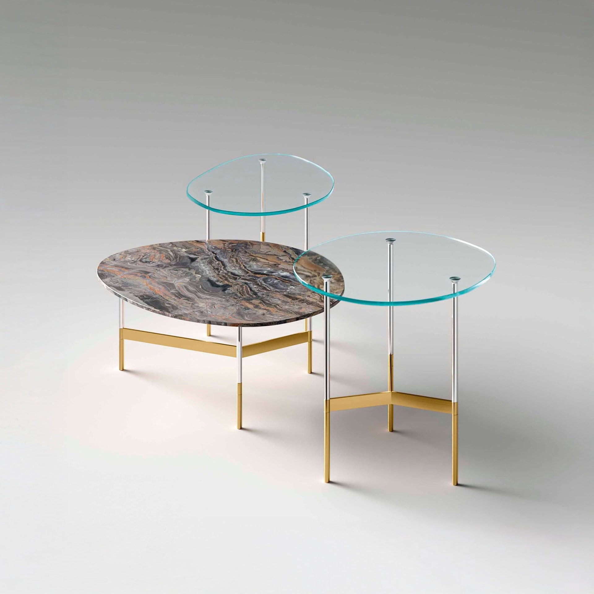 Marble and glass side tables with gold accents, modern living room decor.