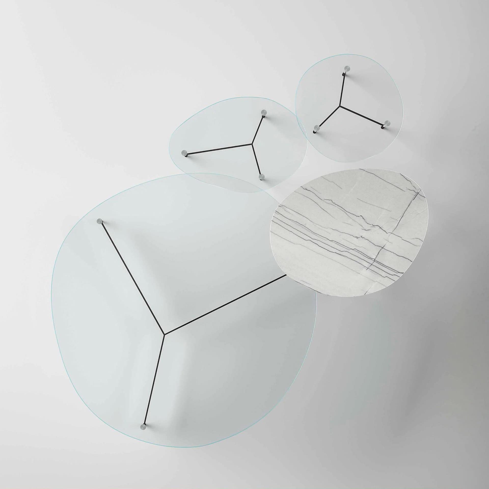 Futuristic glass and marble coffee table with geometric design in modern living room.