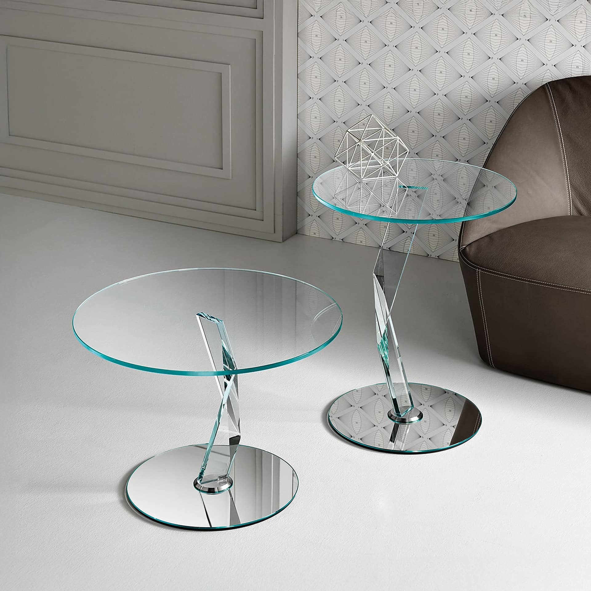 Elegant glass side tables with chrome bases for contemporary living spaces.