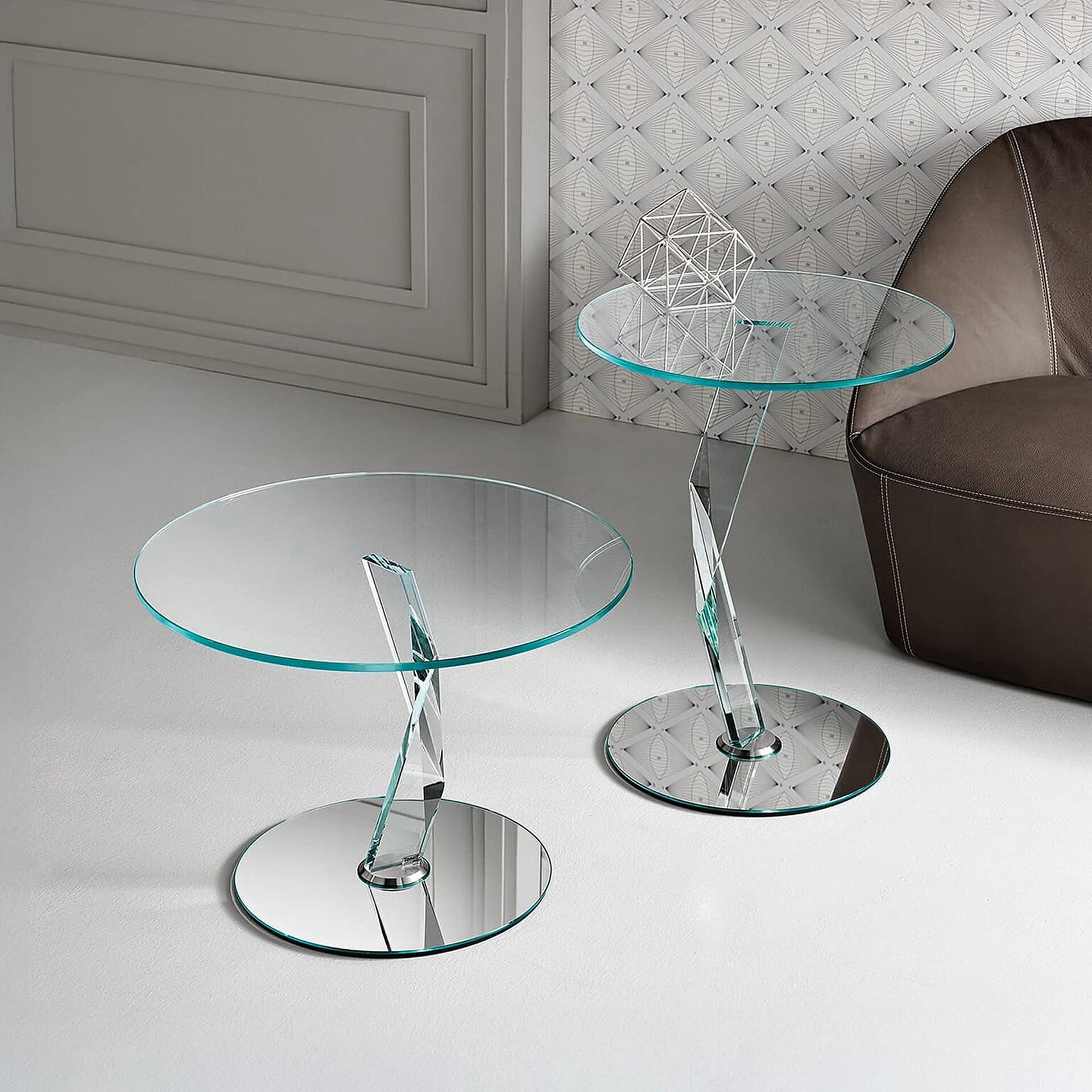 Elegant glass side tables with chrome bases for contemporary living spaces.