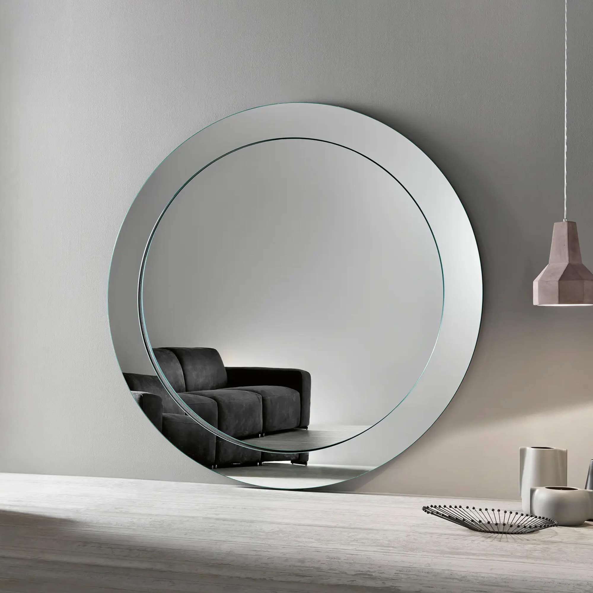 Round wall mirror with modern design, perfect for contemporary interior decor.