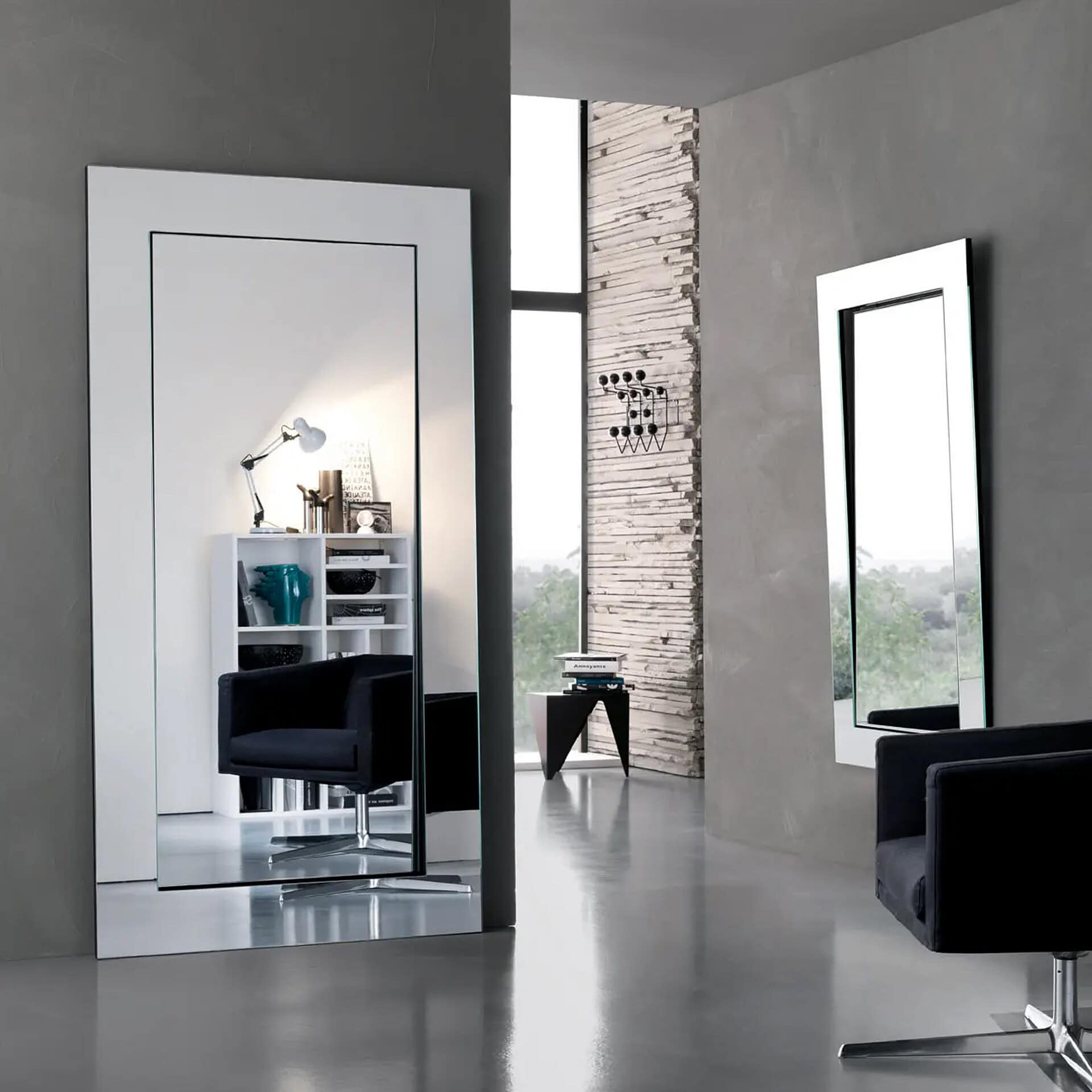 Modern salon with large mirrors and stylish furniture at Sklar Furnishings.