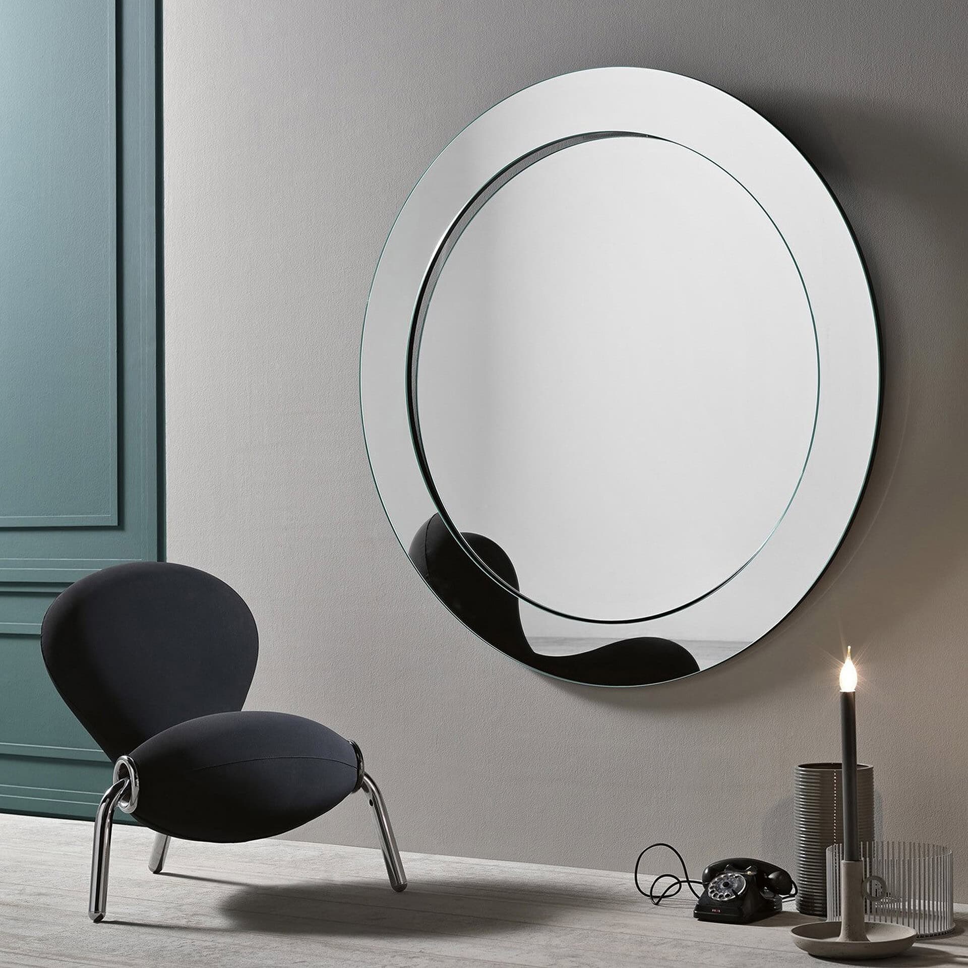Round wall mirror with sleek, minimalist design for contemporary interiors.