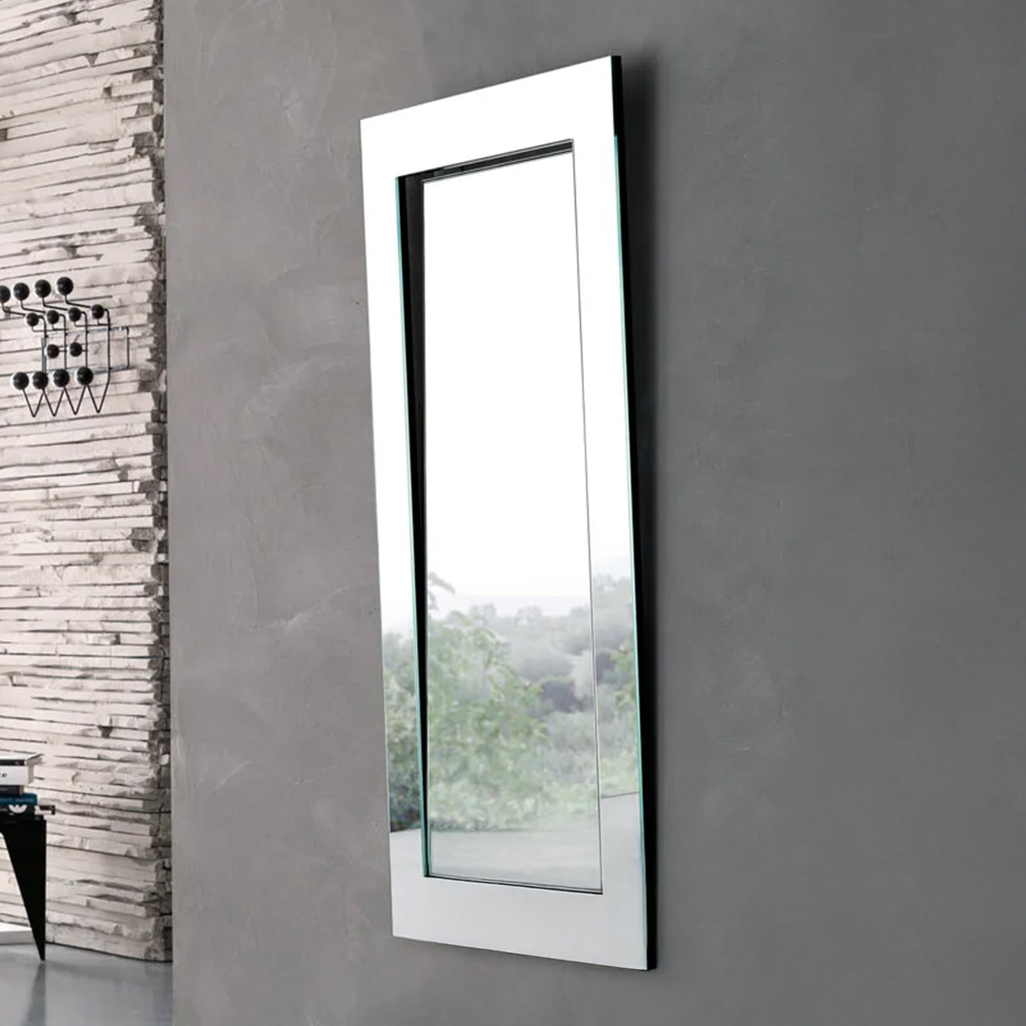 Tonelli Design Gerundio rectangular mirror with inclined glass frame in a loft-style interior.