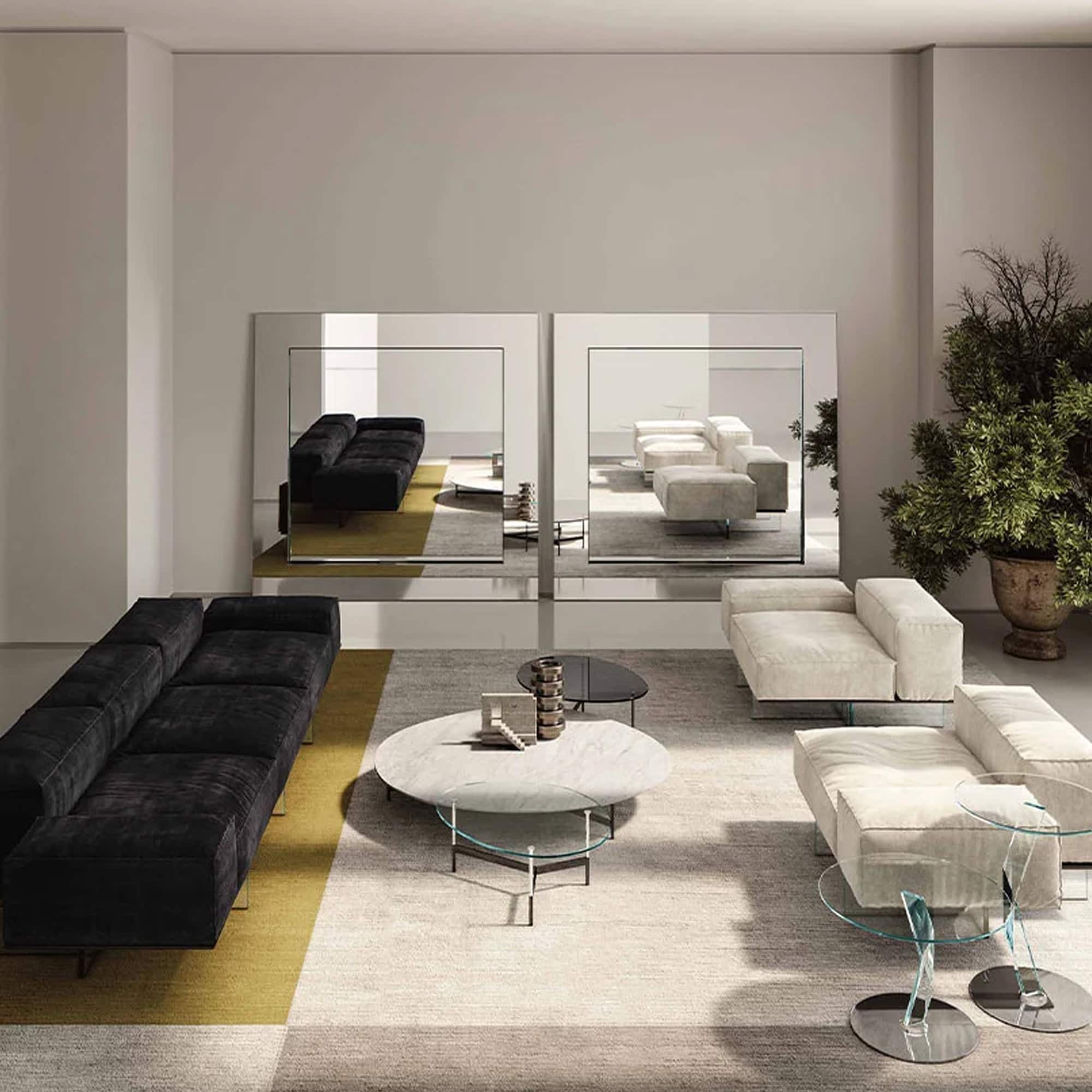 Tonelli Design Gerundio mirrors displayed in a modern living room with sofa and coffee table.