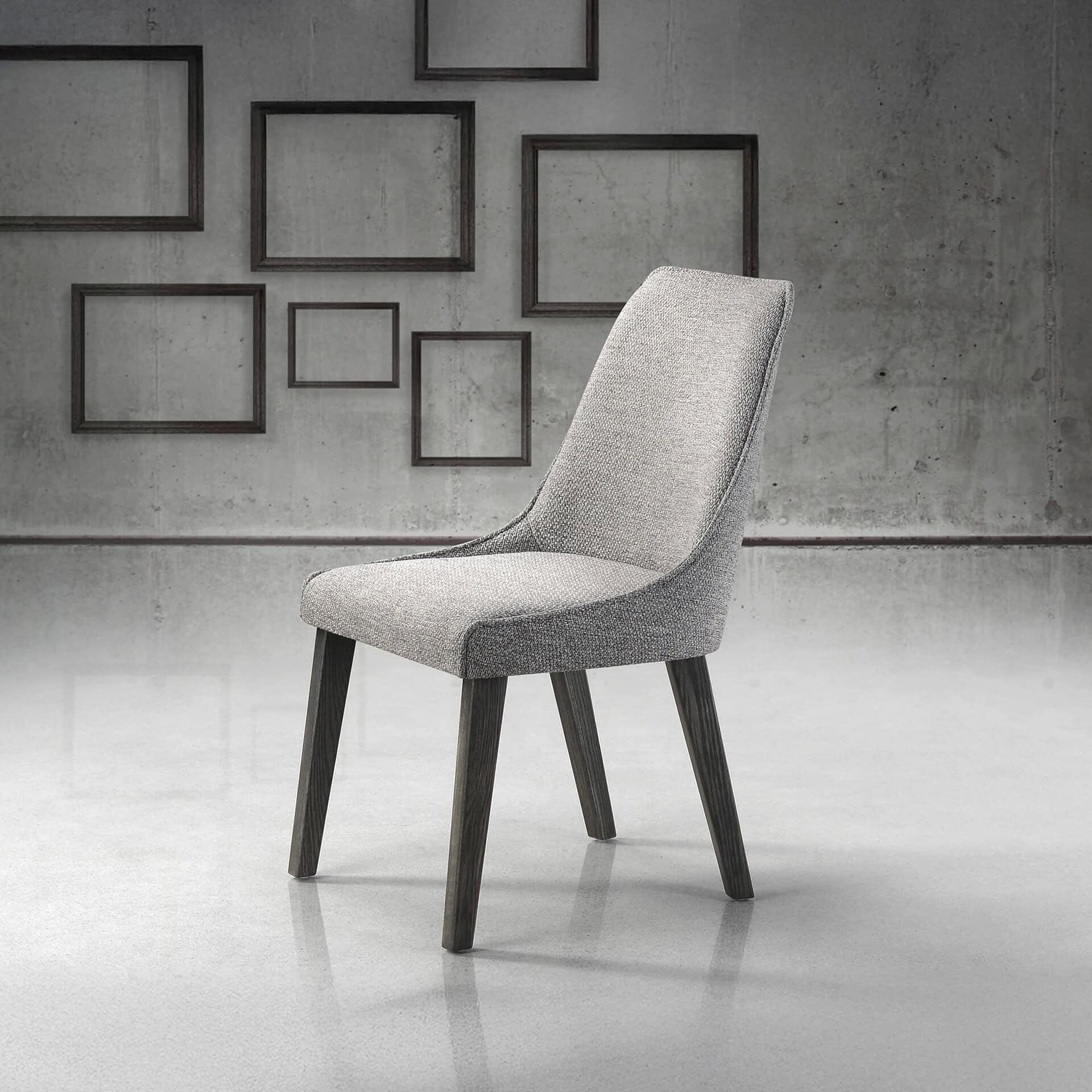 Front angled view of the Trica Olivia Chair in a light upholstered fabric with wooden legs, styled against a decorative wall backdrop.