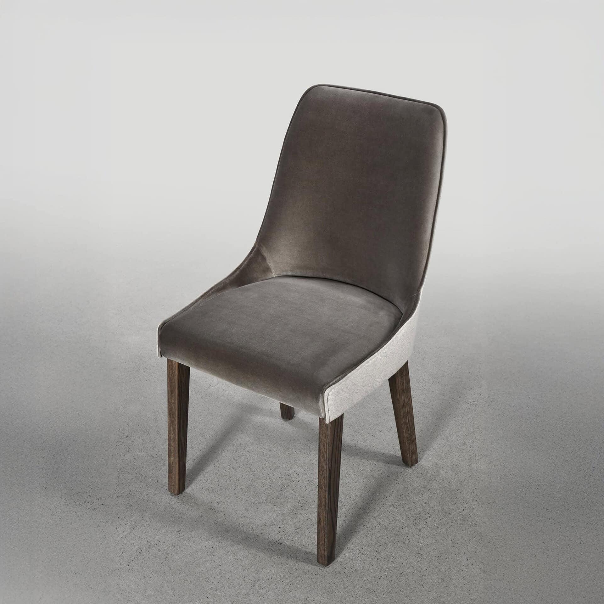 Trica Olivia Chair in a dark leather finish with wooden legs, highlighting material contrast and versatile design.