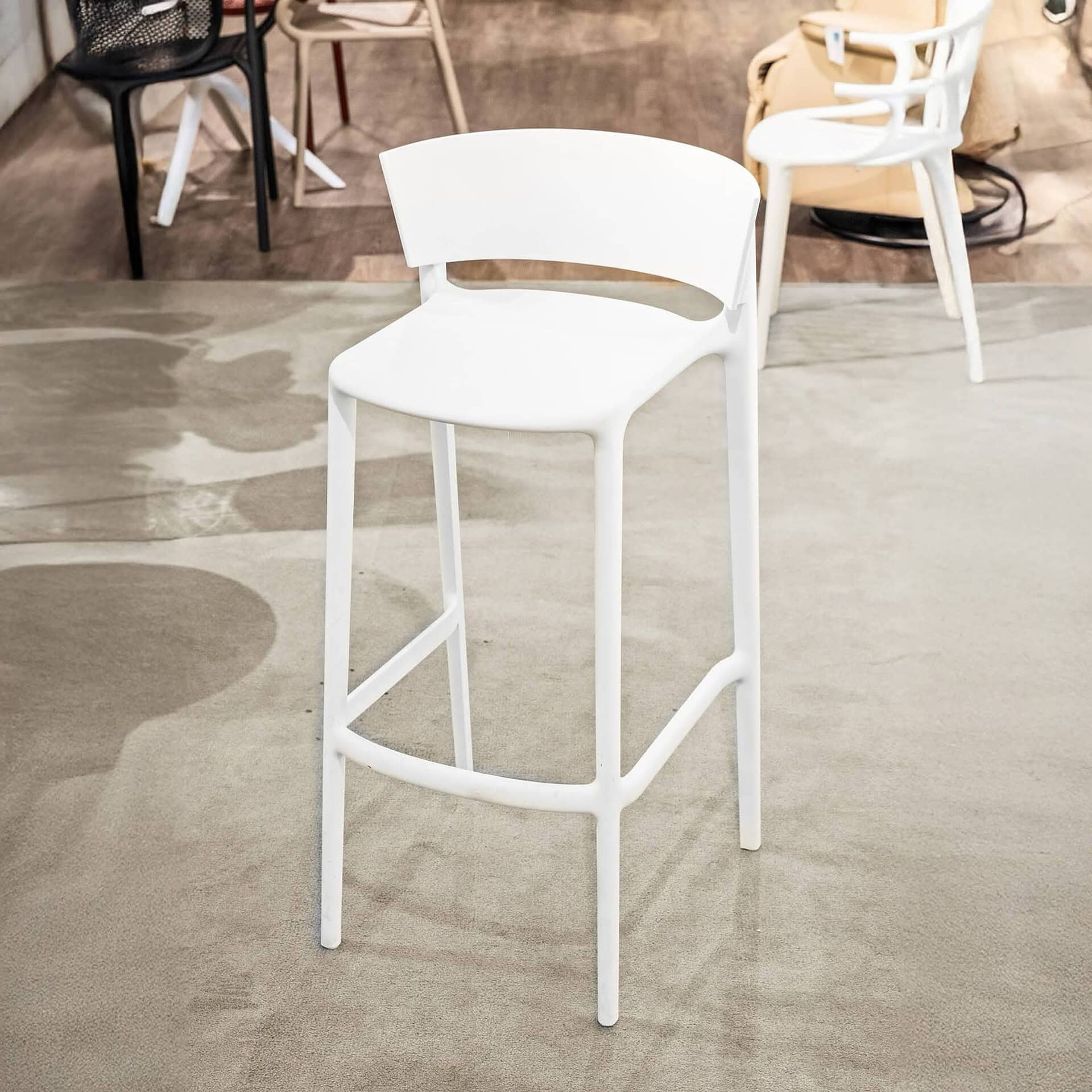 Modern white bar stool with sleek design, perfect for contemporary kitchen or bar areas.
