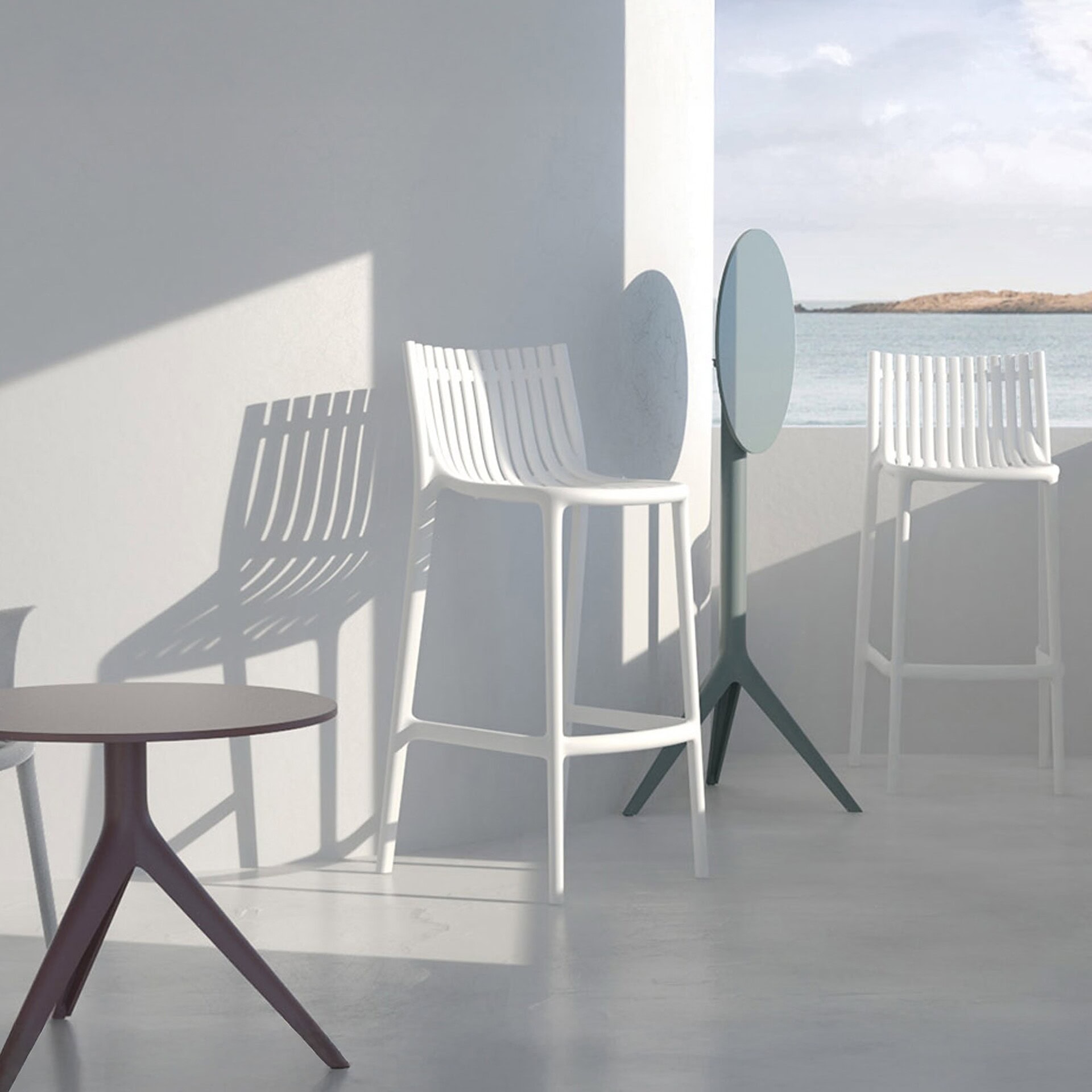 Ibiza Stools by Vondom styled in a modern outdoor dining space