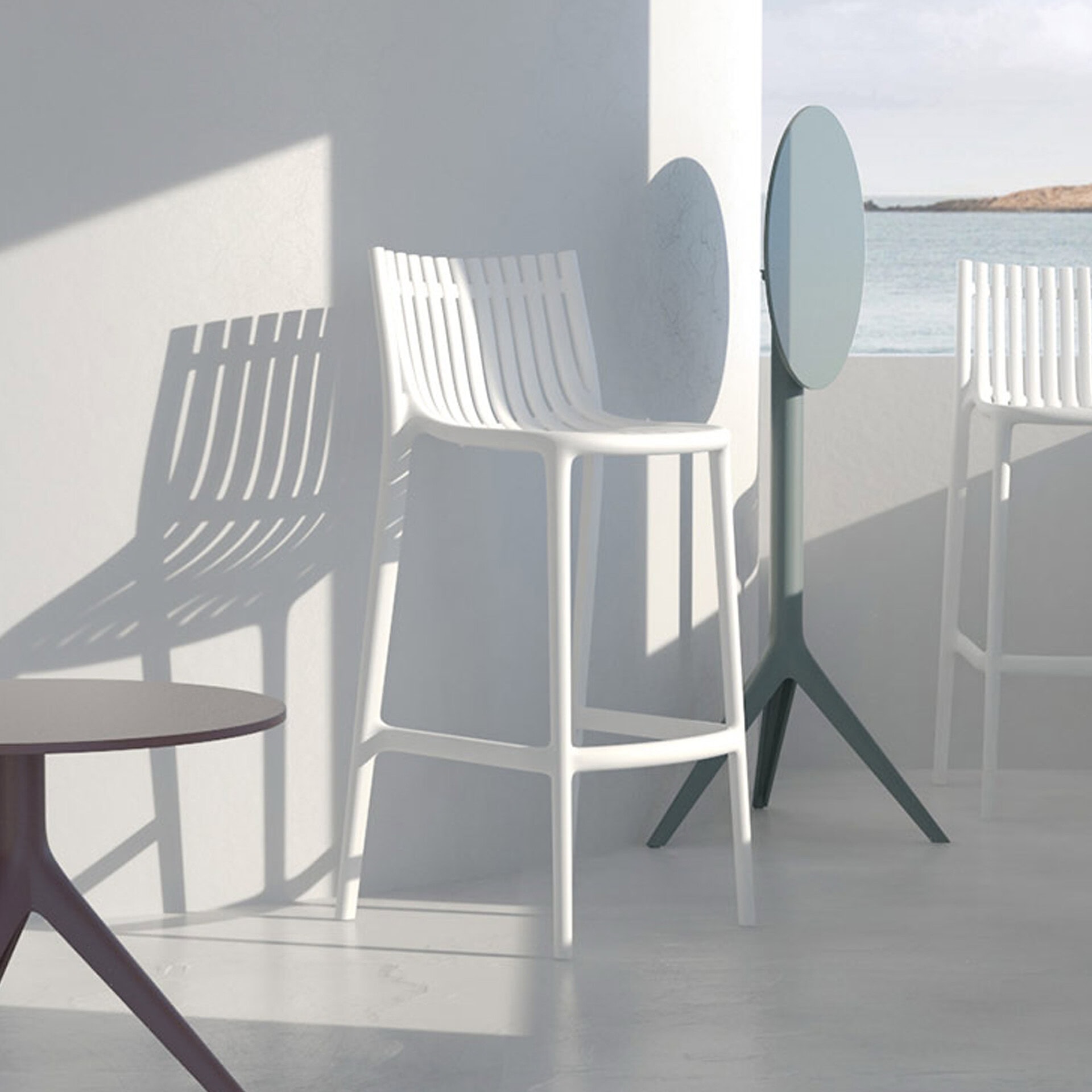 Ibiza Stools by Vondom styled in a modern outdoor dining space