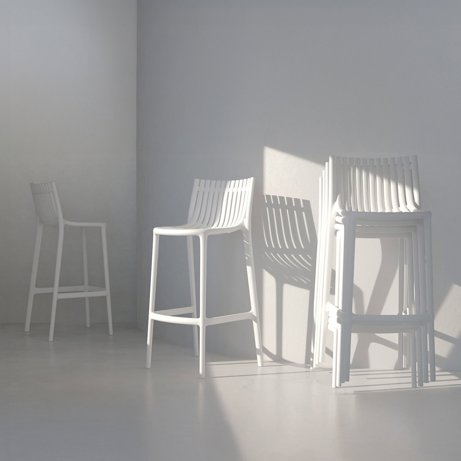 Stackable Ibiza Stools by Vondom in a minimalist exterior setting