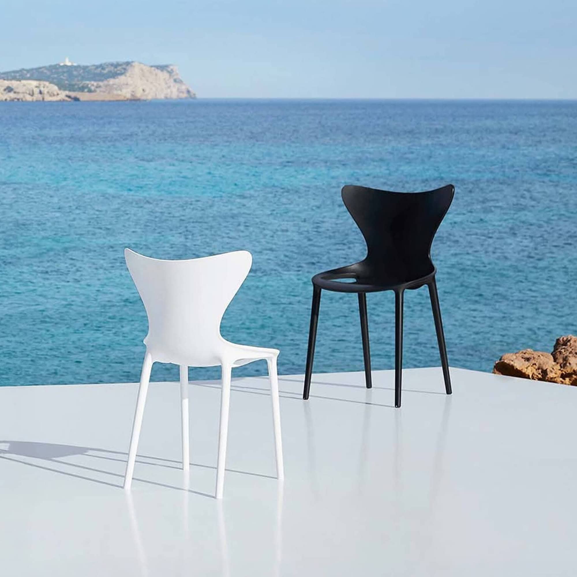 Black and white modern chairs by the seaside for contemporary furniture design.