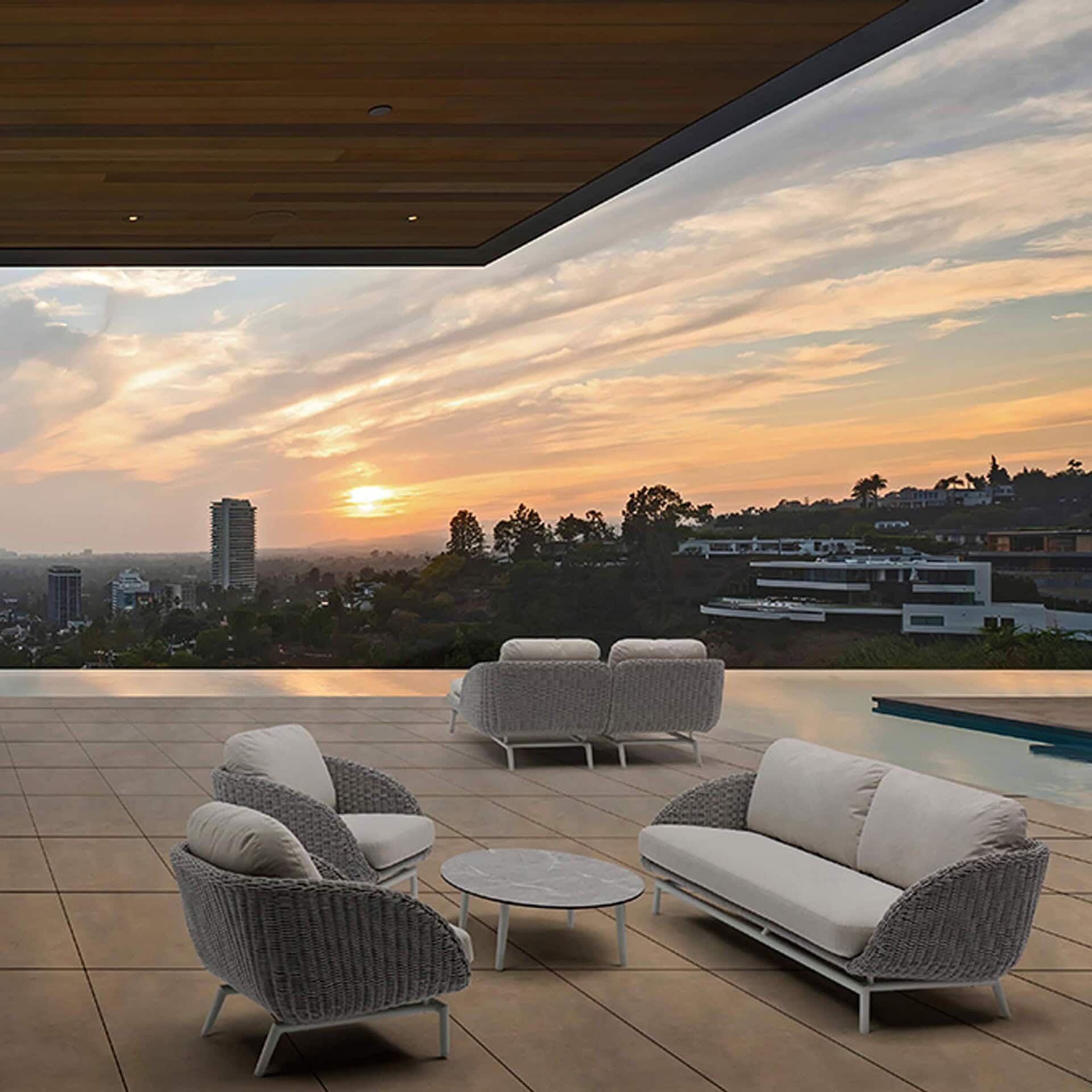 Scoop Coffee Table on a modern terrace with sofa set, at sunset.