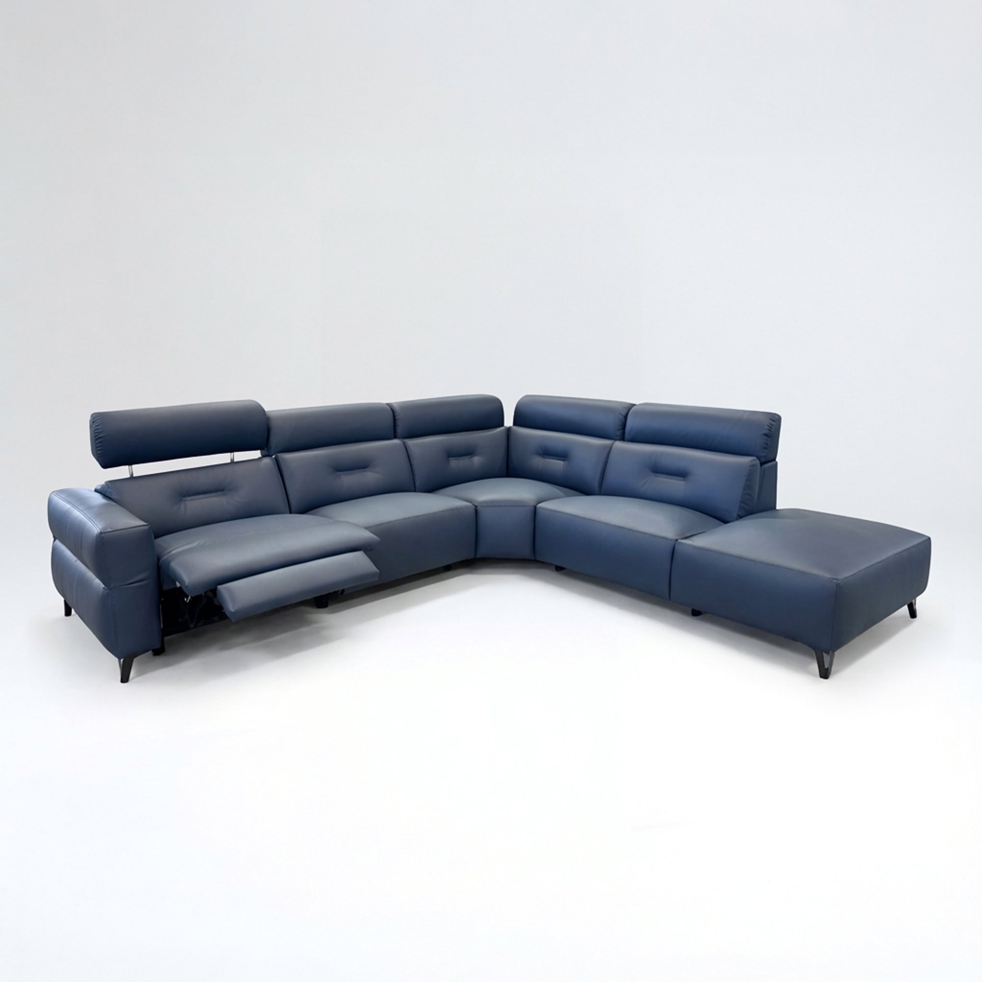 Luxurious navy blue leather sectional sofa with adjustable headrests and chaise lounge. Perfect for modern living rooms.