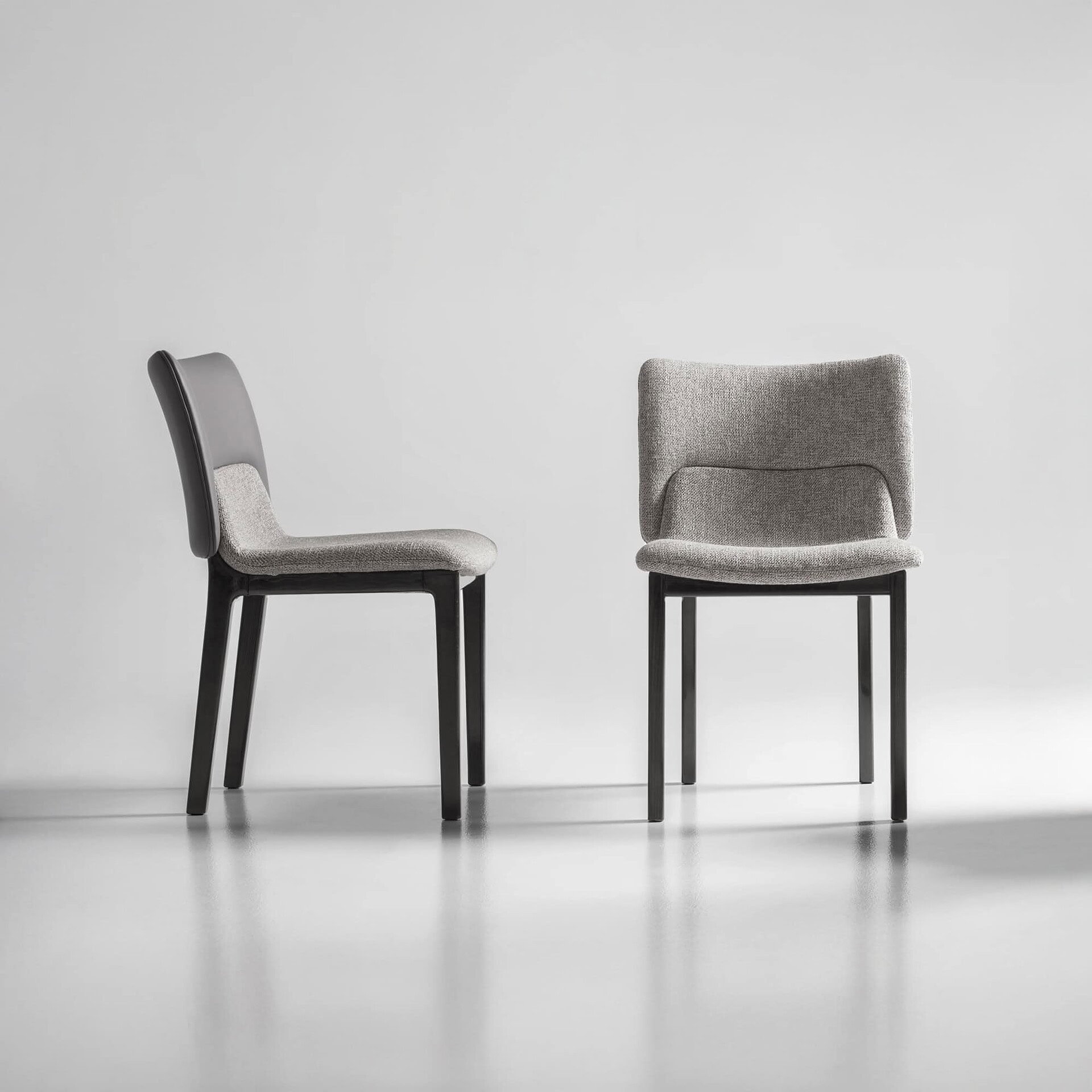 Side view of the Nora Dining Chair with upholstered seat and backrest.