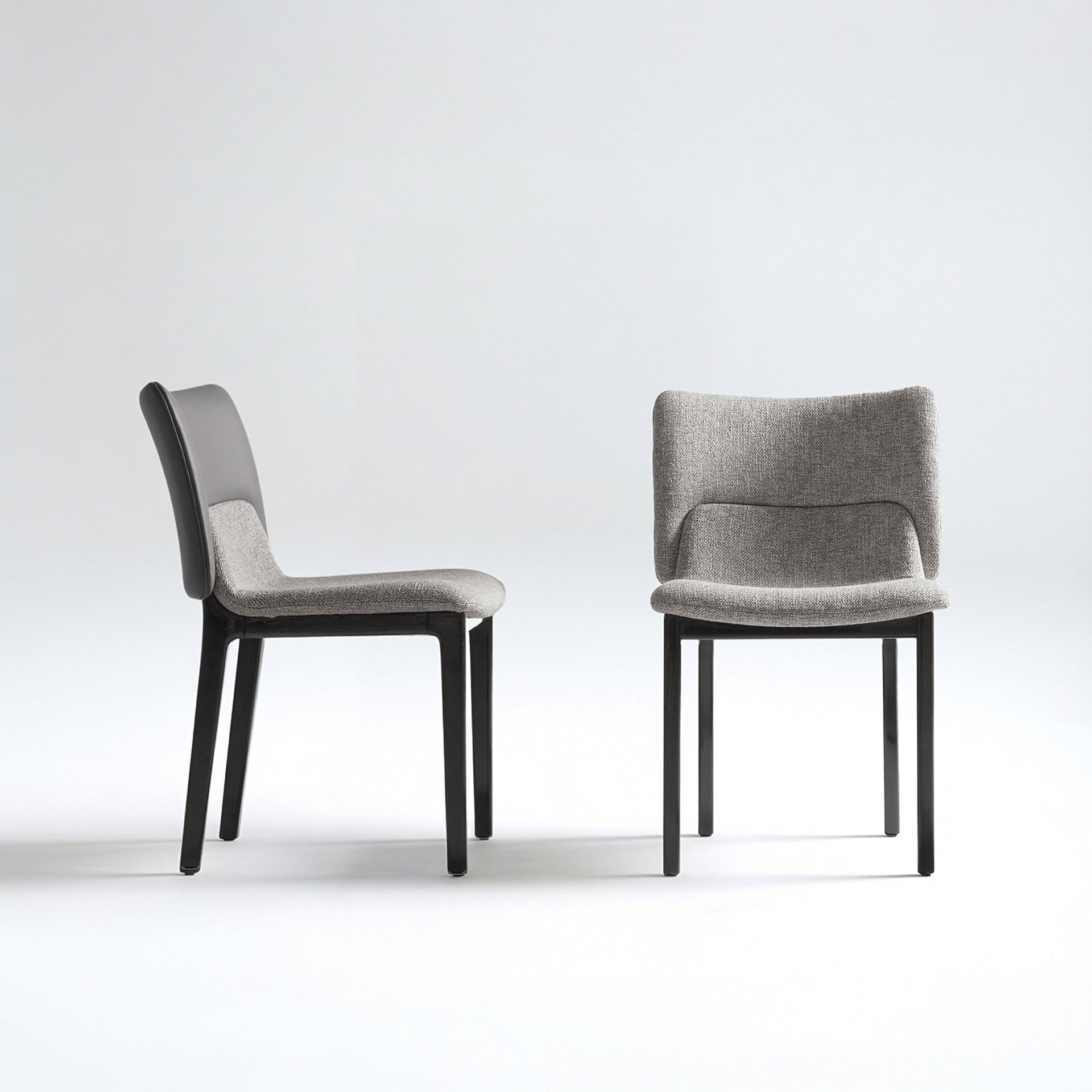 Side view of the Nora Dining Chair with upholstered seat and backrest.