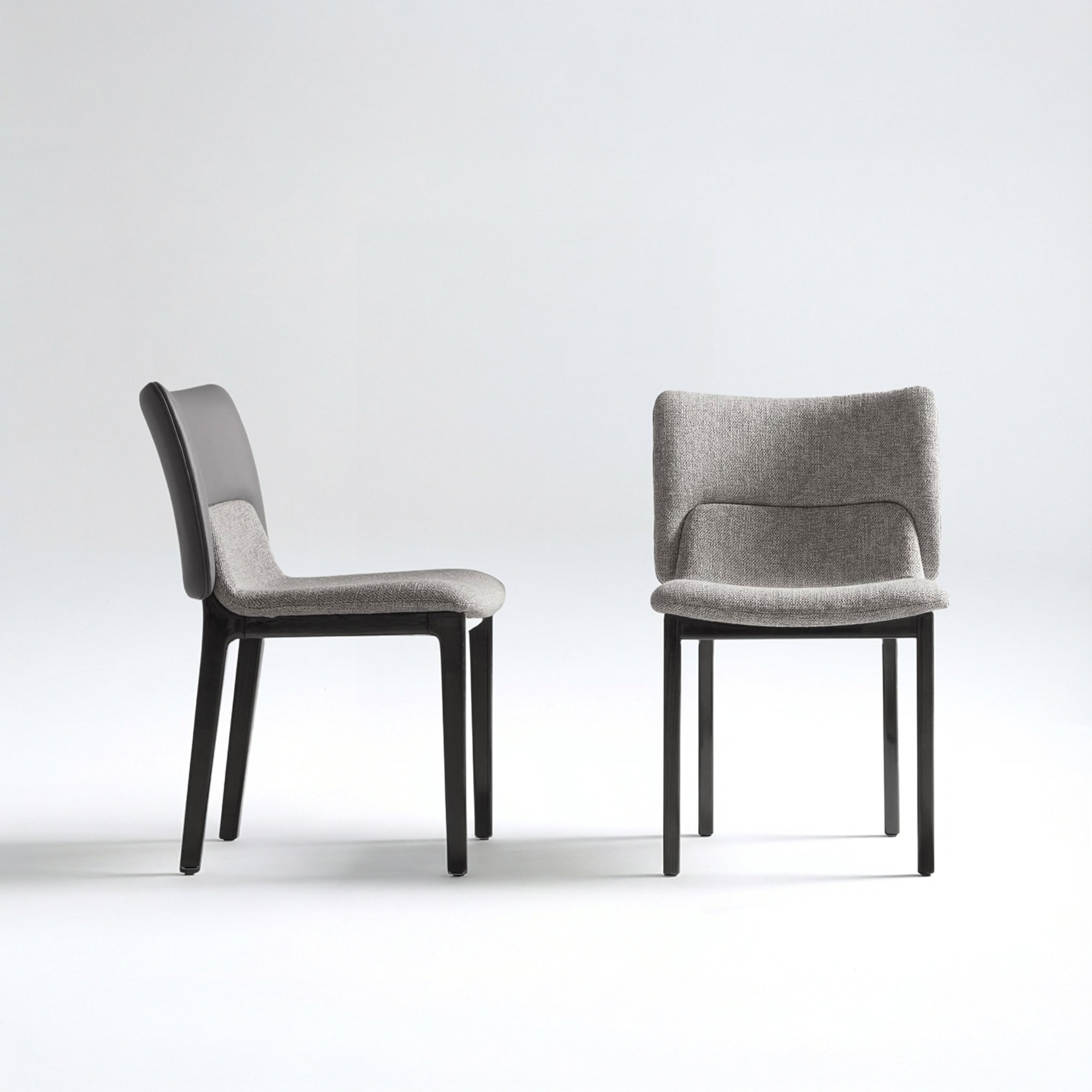 Side view of the Nora Dining Chair with upholstered seat and backrest.