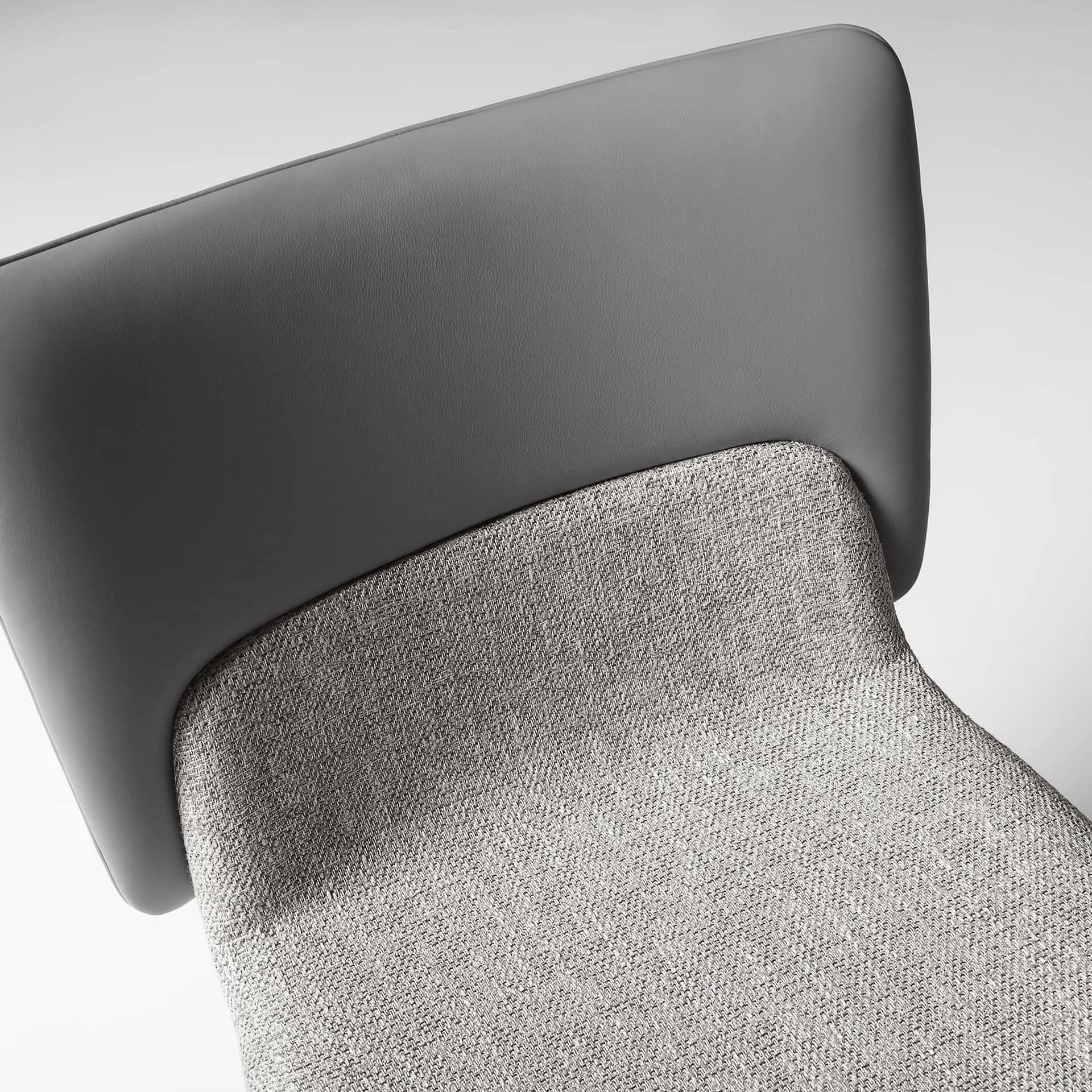 Detail of the Nora Dining Chair’s upholstered backrest and seam finish.