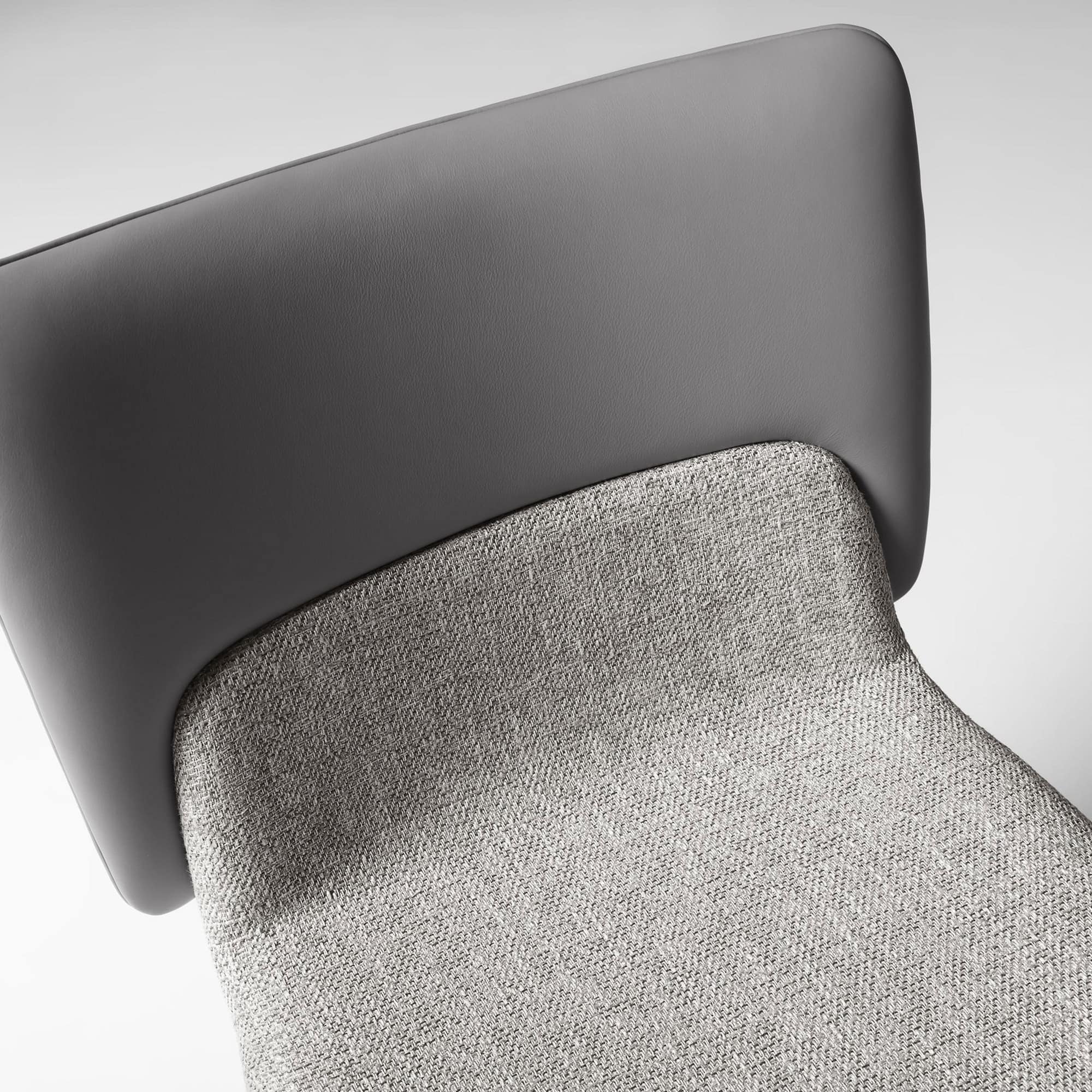 Detail of the Nora Dining Chair’s upholstered backrest and seam finish.