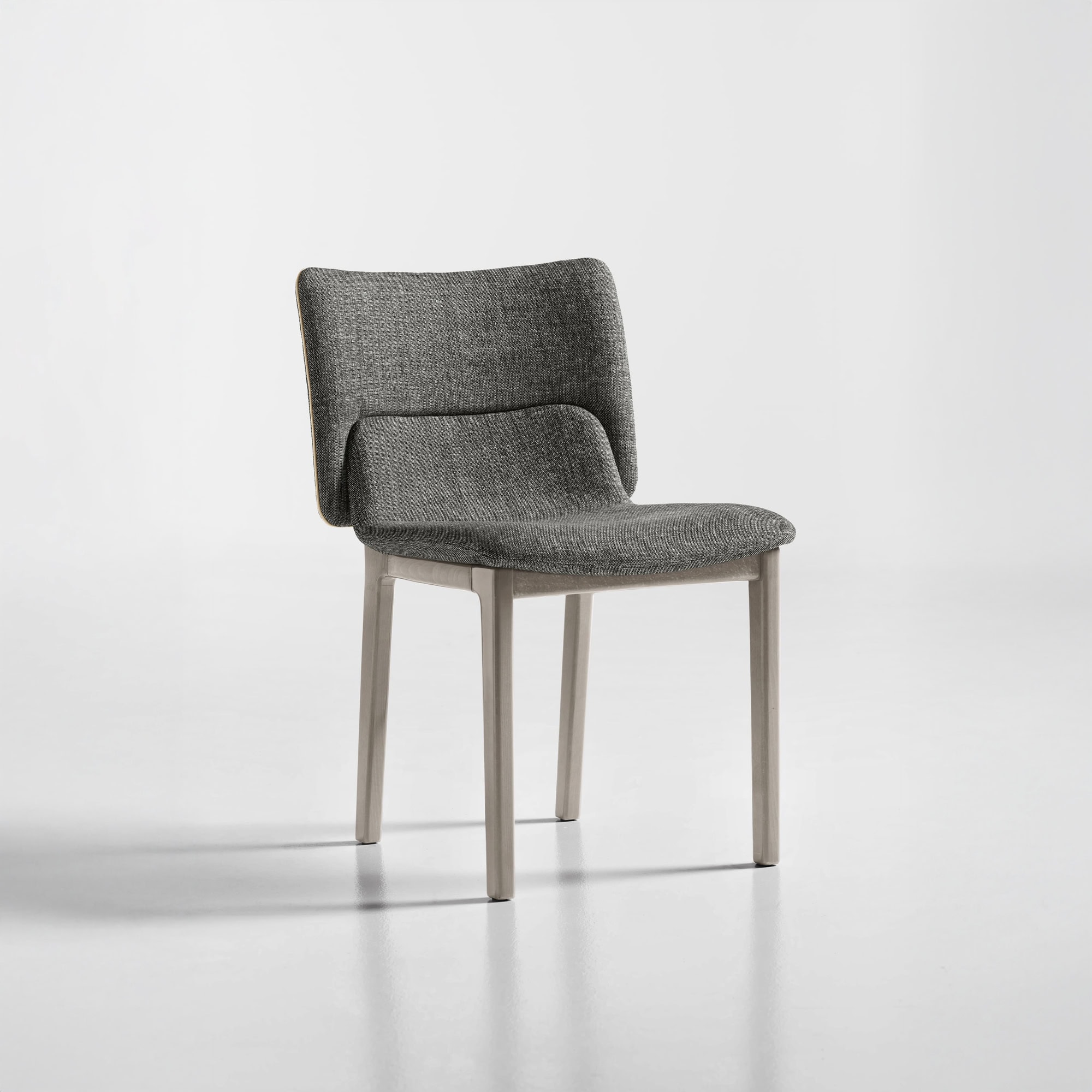 Front angled view of the Nora Dining Chair in light fabric with wooden legs.