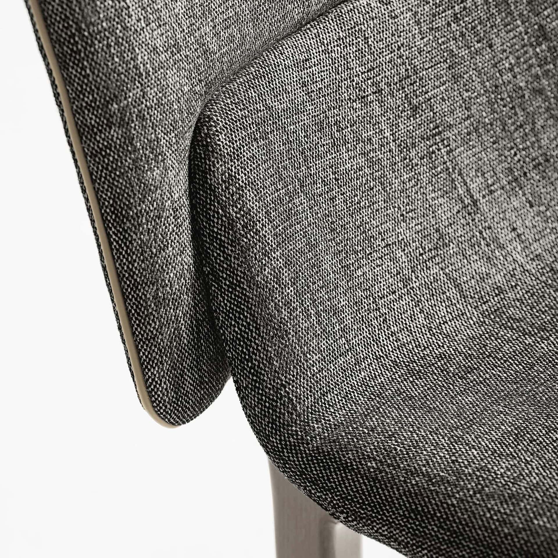 Close-up of the Nora Dining Chair upholstery texture and stitching.