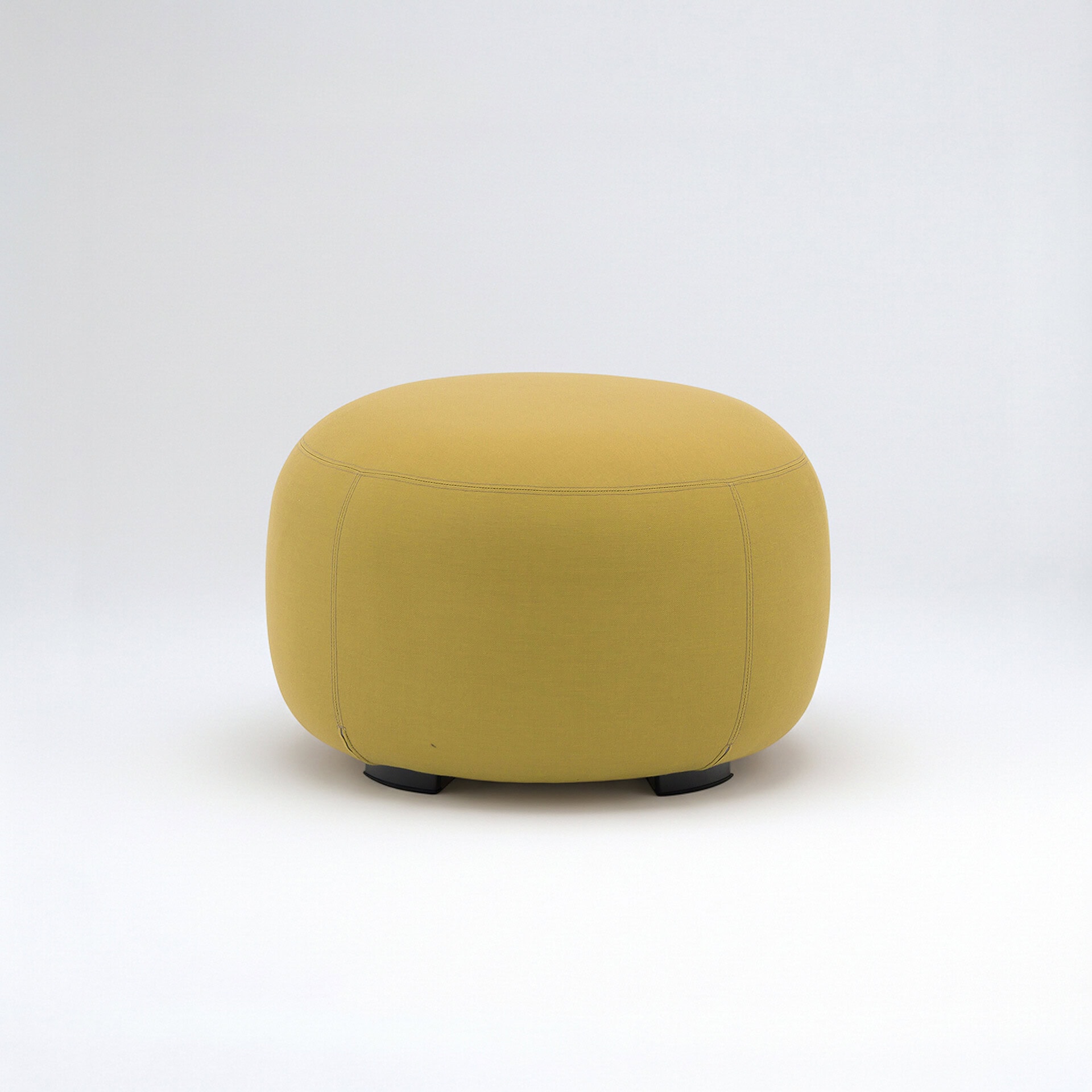 Yellow outdoor ottoman with rounded design for patio seating.