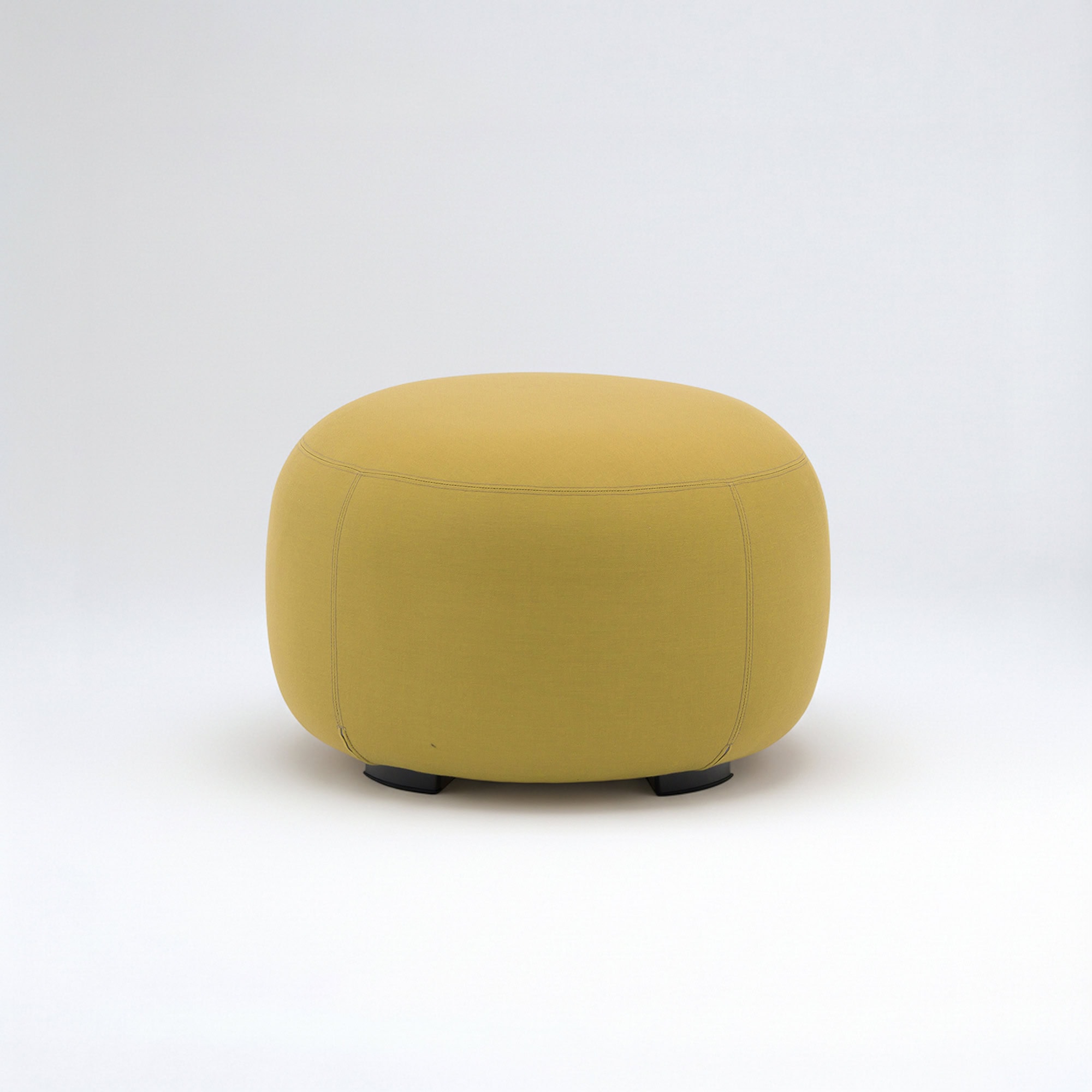 Yellow outdoor ottoman with rounded design for patio seating.