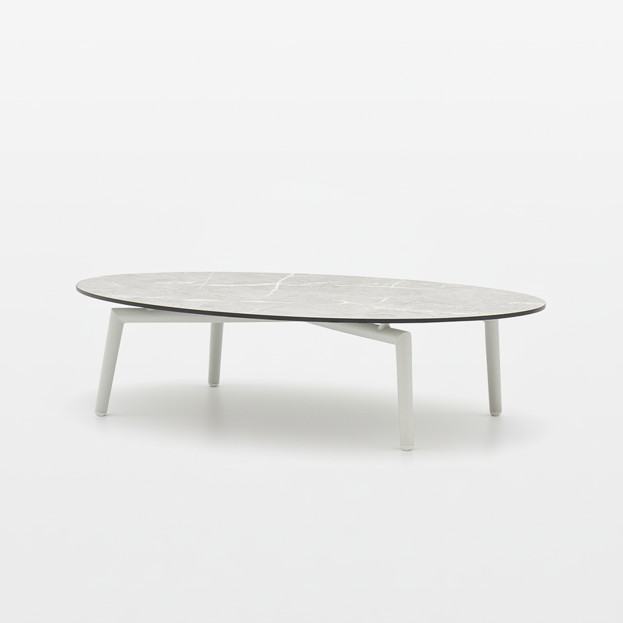 Modern oval coffee table with a light grey marble-patterned top and white, slender legs on a white background.