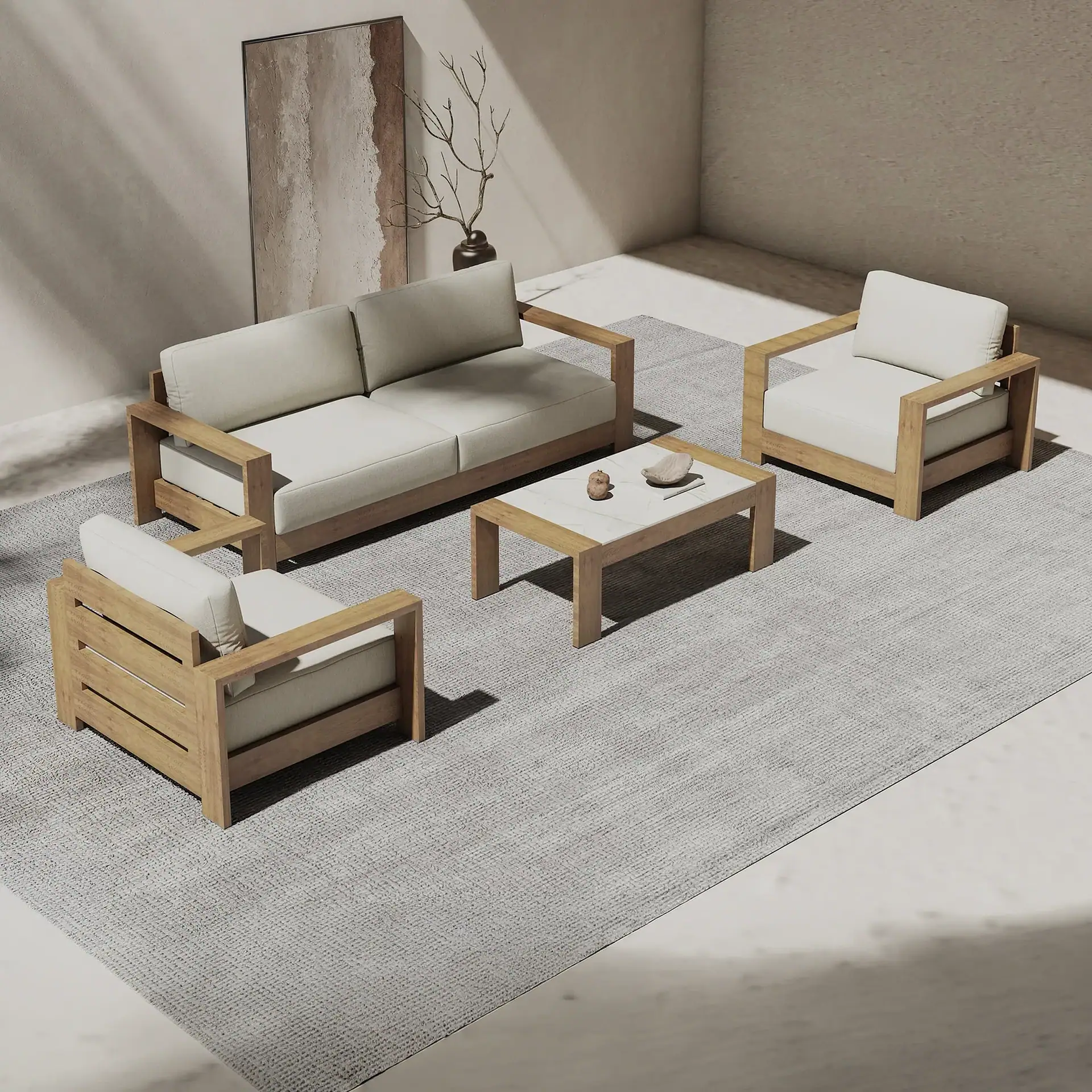A modern living room setup with a light gray rug, wooden sofa, two armchairs, and a coffee table with a marble top. Abstract art and dried branches are visible in the background.