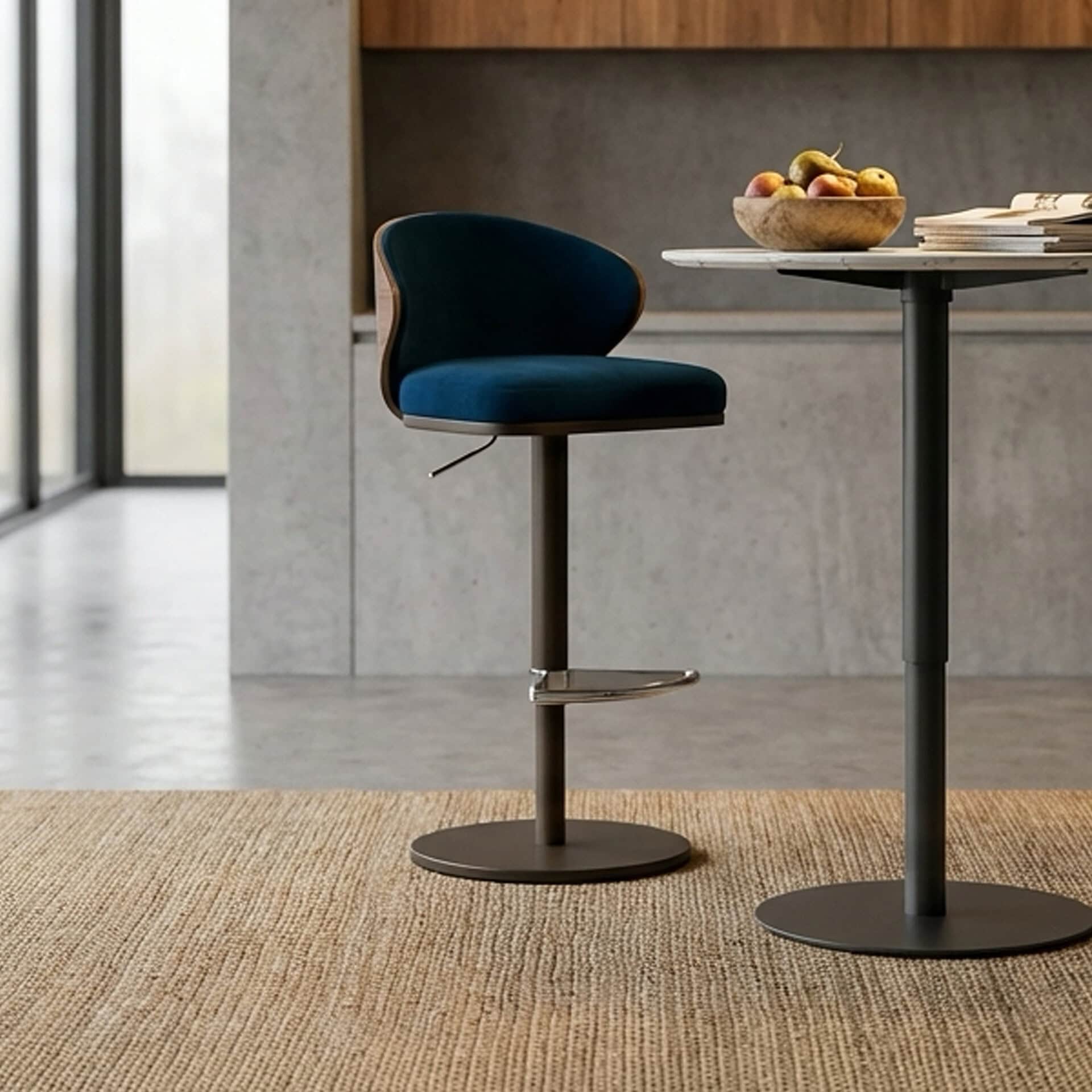 Upholstered Seville bar stool with modern design and navy blue fabric. Perfect for contemporary kitc.