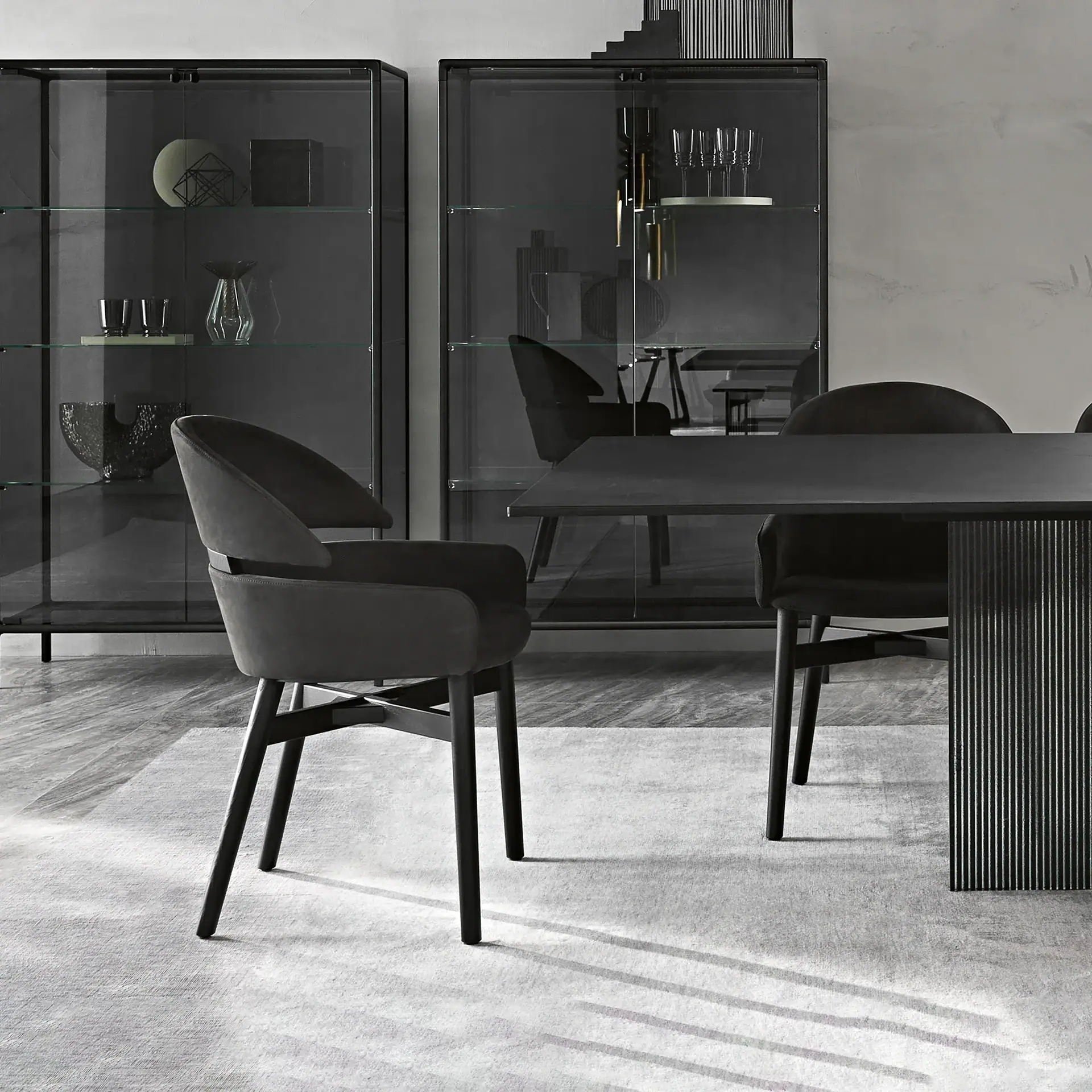 Contemporary dining room featuring Lloyd dining chairs and glass display cabinets.