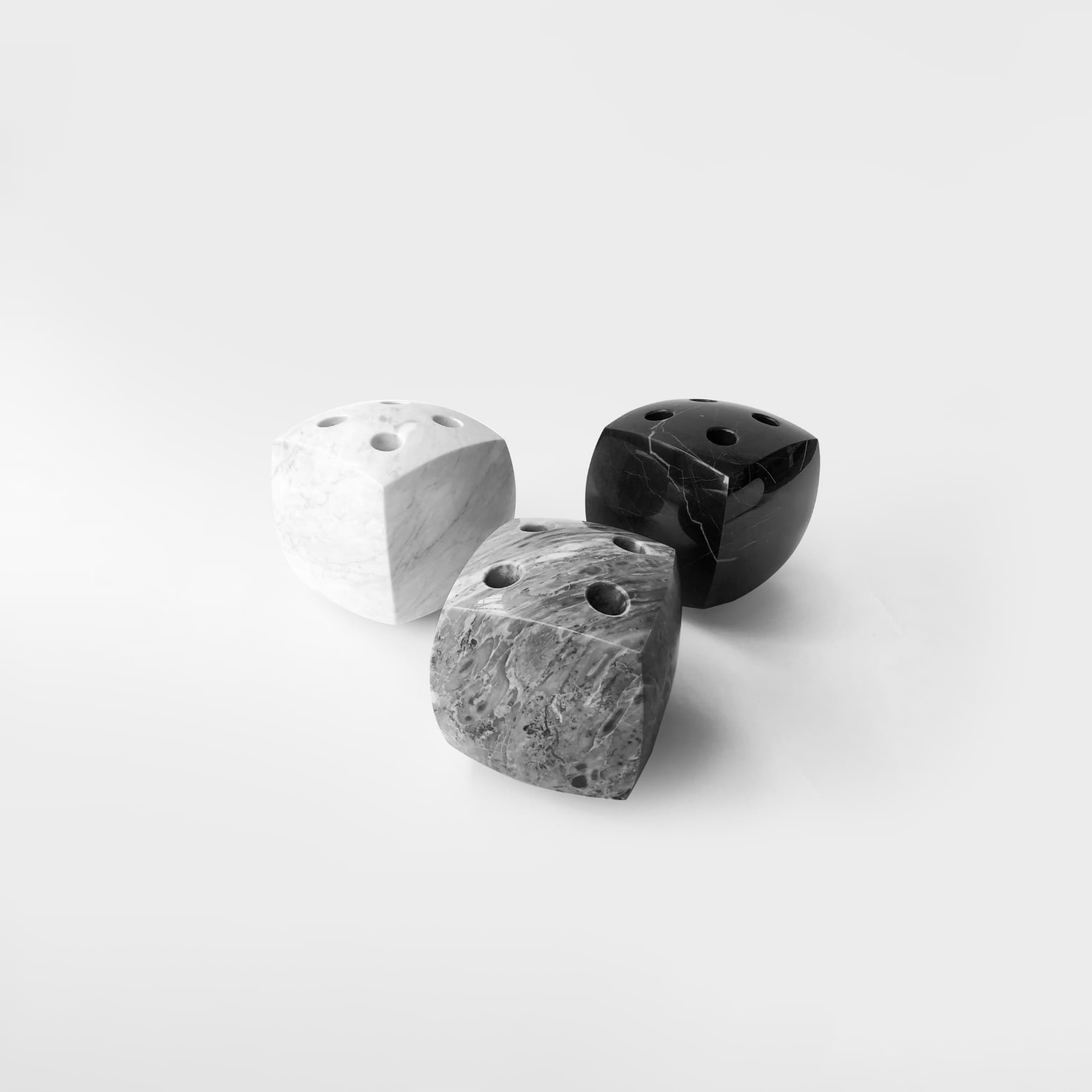 Sleek marble dice set with black, white, and gray designs for modern tabletop gaming.