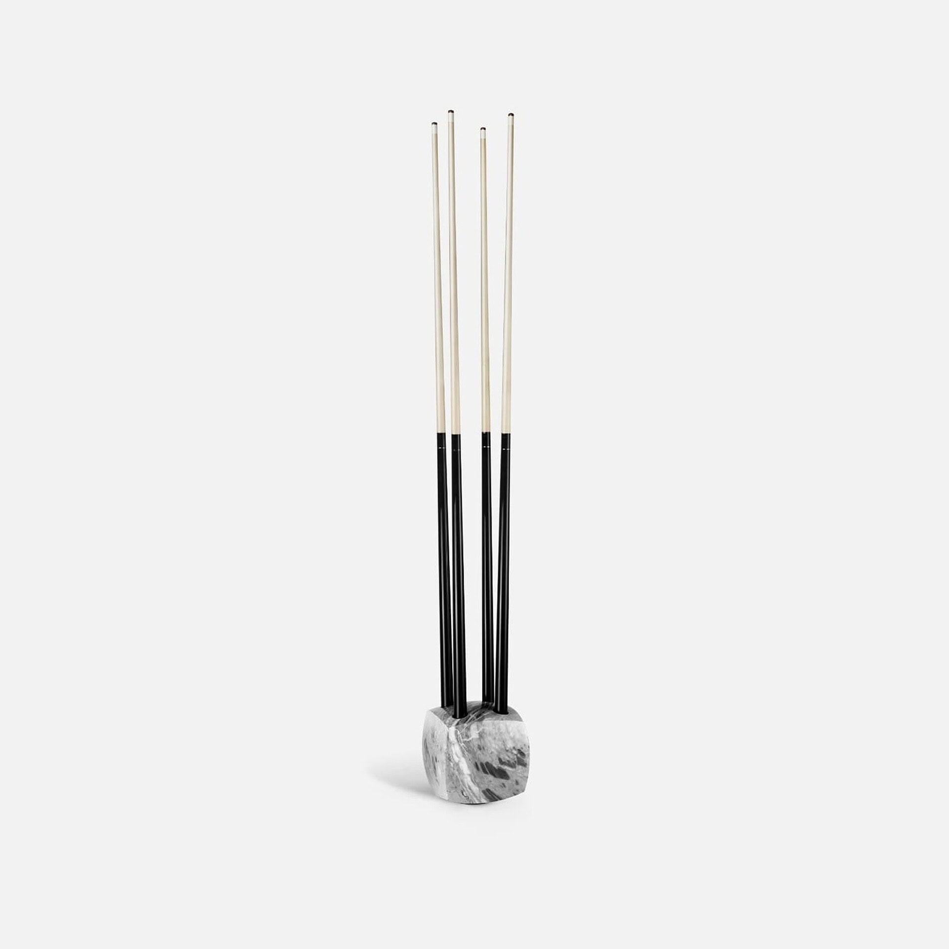 Contemporary fireplace tools with black and white handle design on marble base for modern homes.