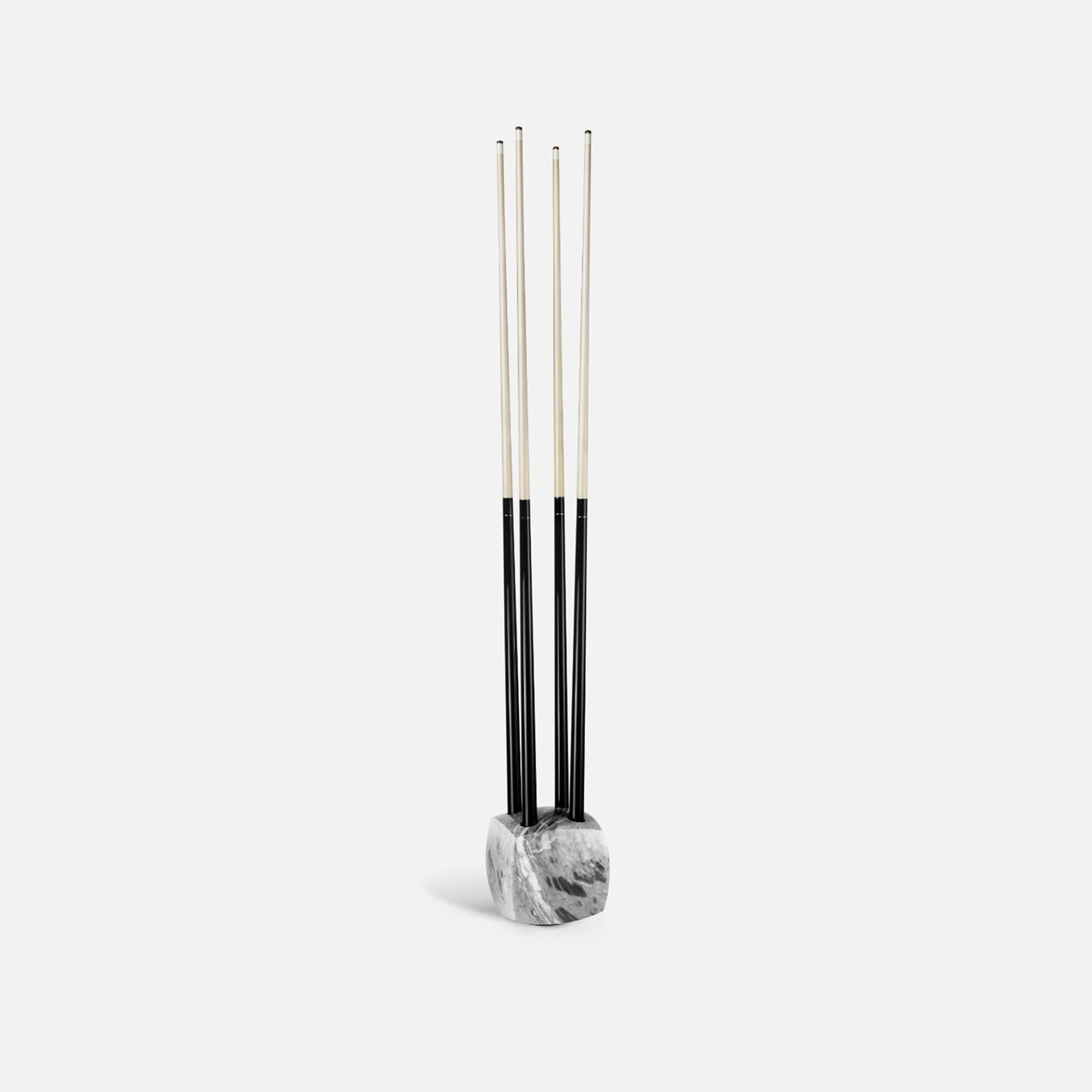 Contemporary fireplace tools with black and white handle design on marble base for modern homes.