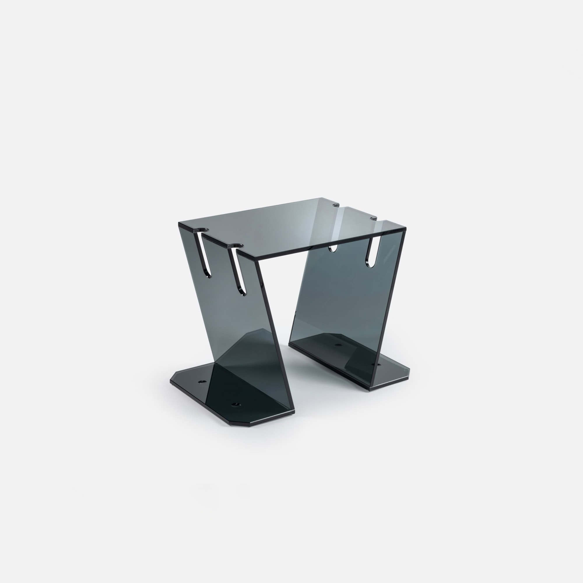 Sleek modern glass side table with black metal accents, contemporary furniture design.