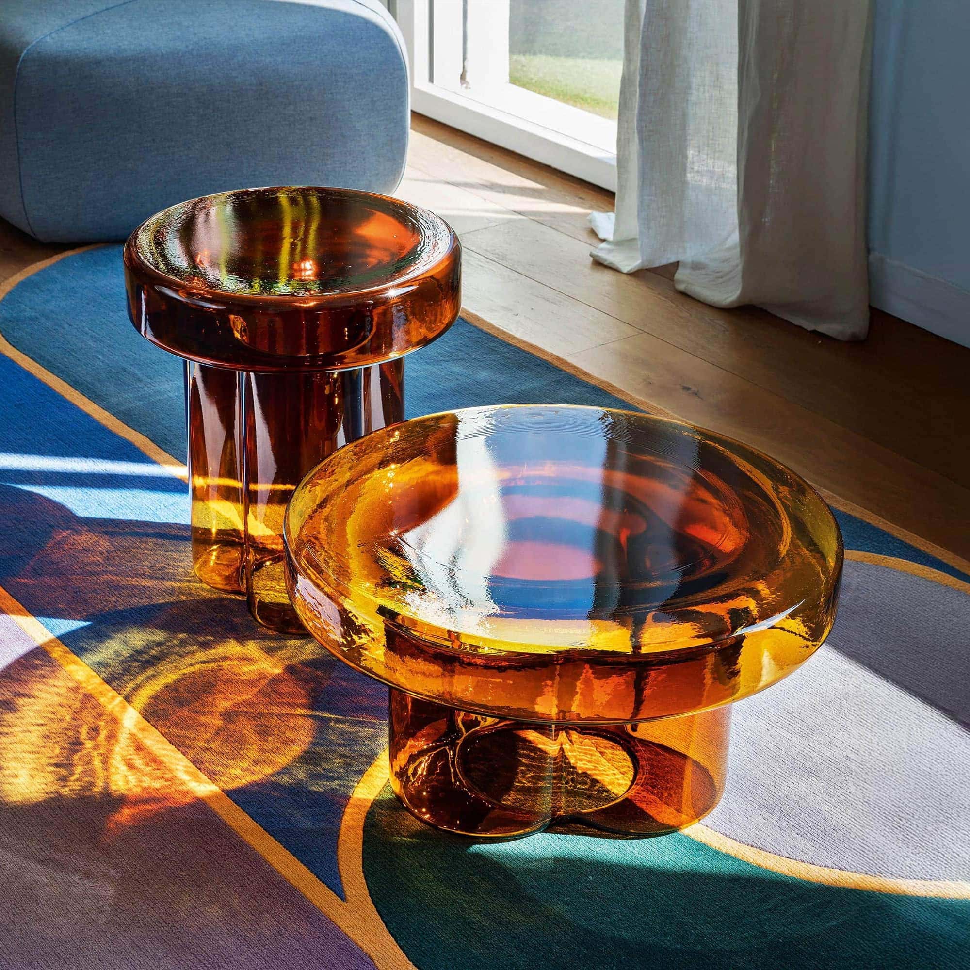 Amber glass side tables with a sleek, contemporary design. Perfect for adding a touch of elegance to.